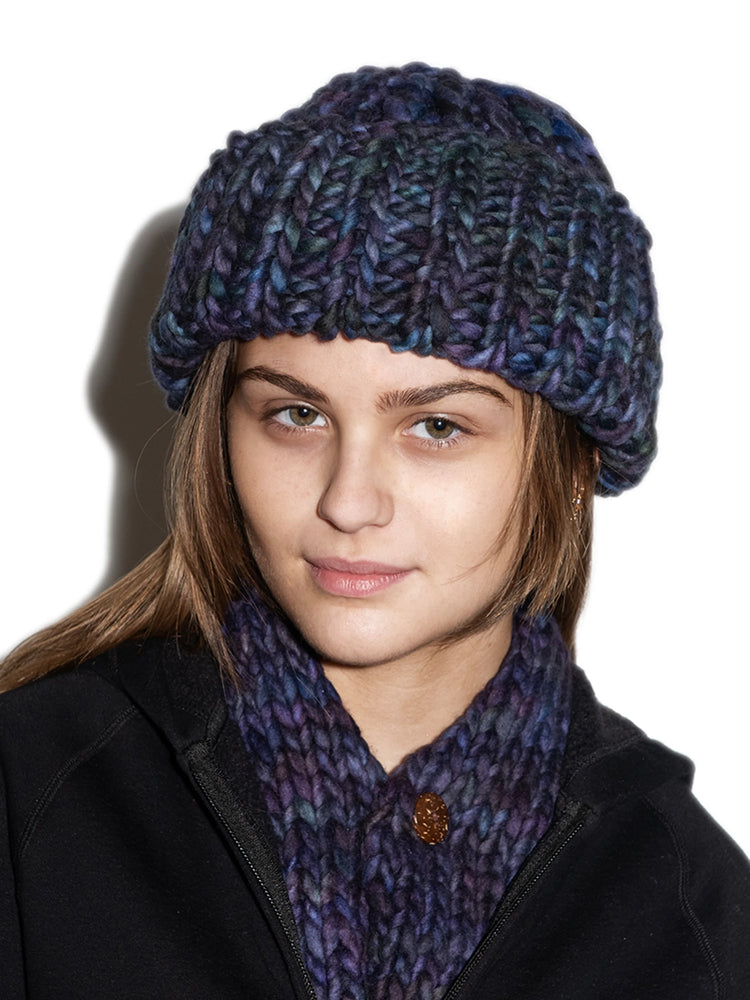 Dark purple, blue, and green chunky knit beanie. Close-fitting, ribbed texture.