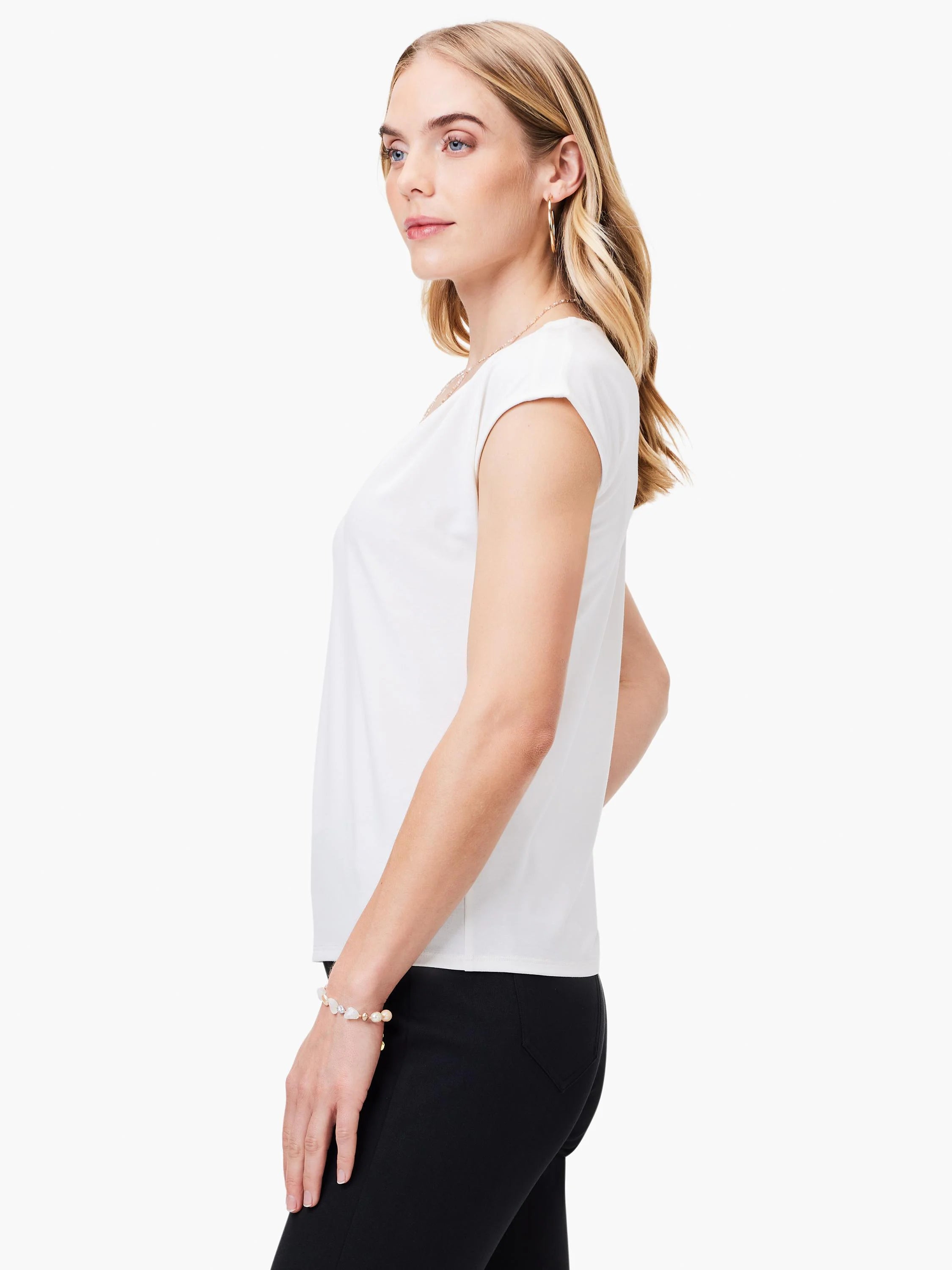 Off-white, short-sleeved, close-fitting jersey top. Side profile shown.