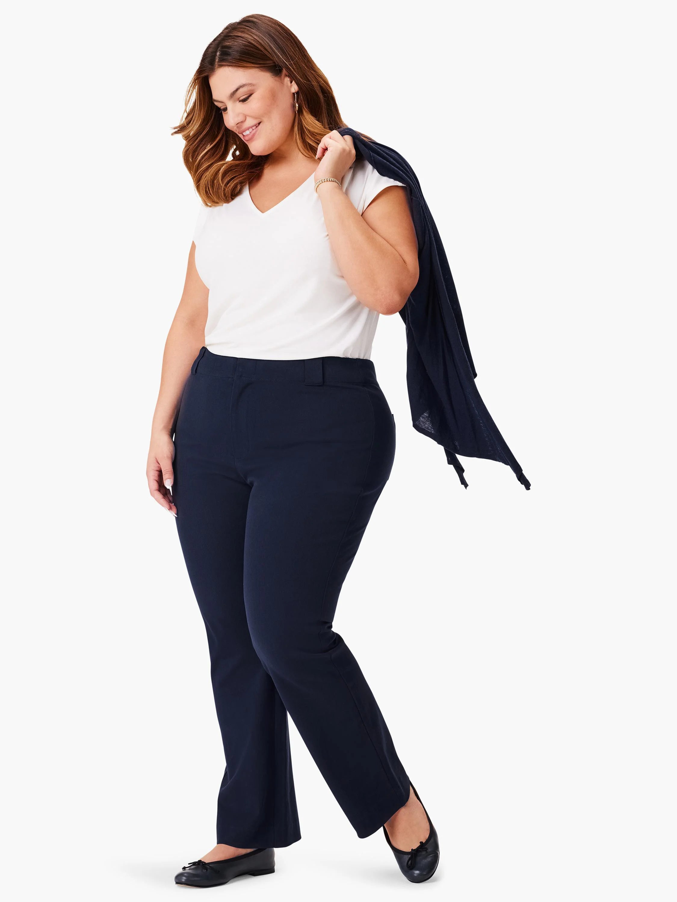 Navy blue bootcut pants; model wears a white shirt and dark cardigan.