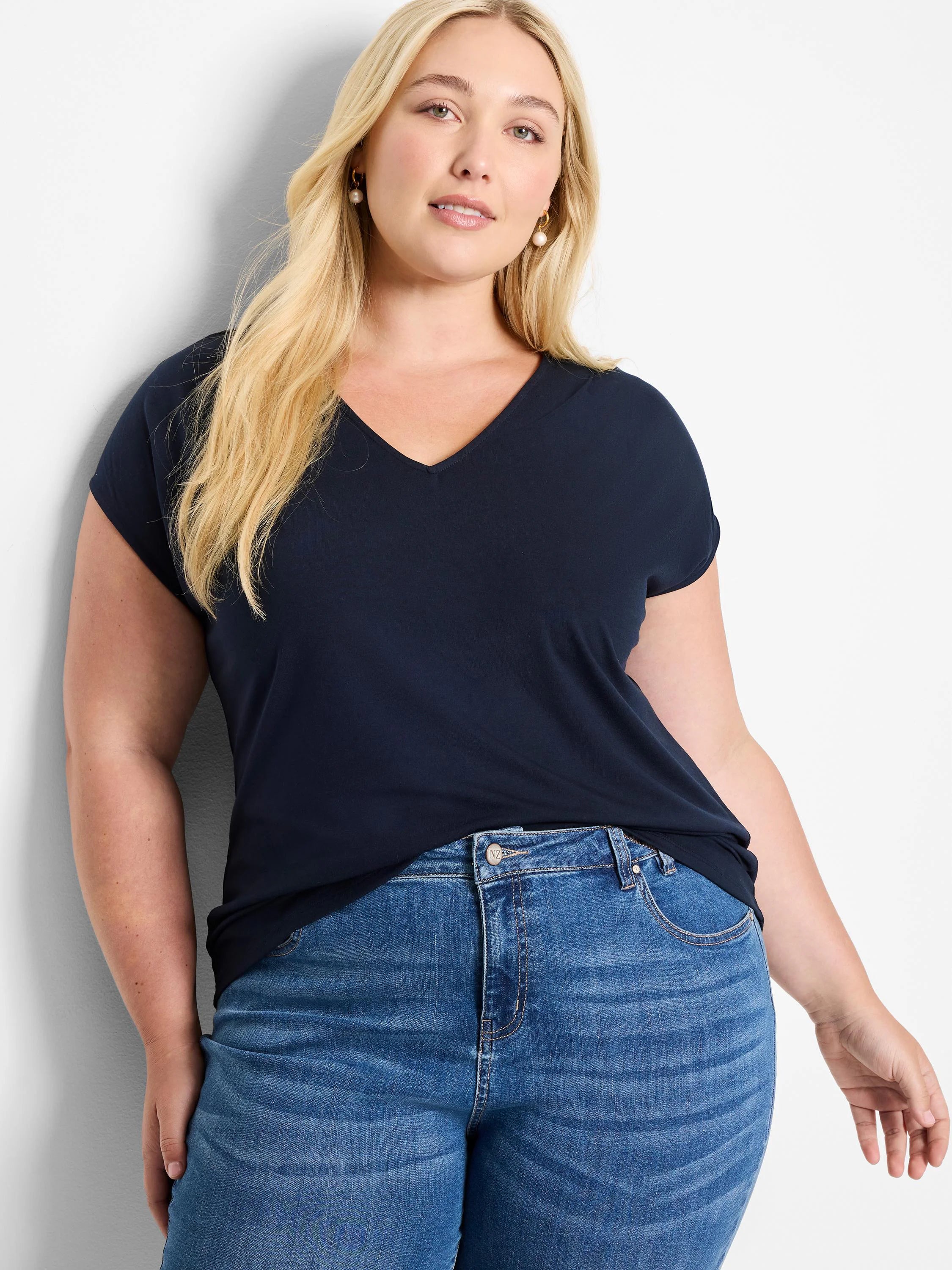 Navy blue, V-neck short-sleeve jersey top. Shown on model with light wash jeans.