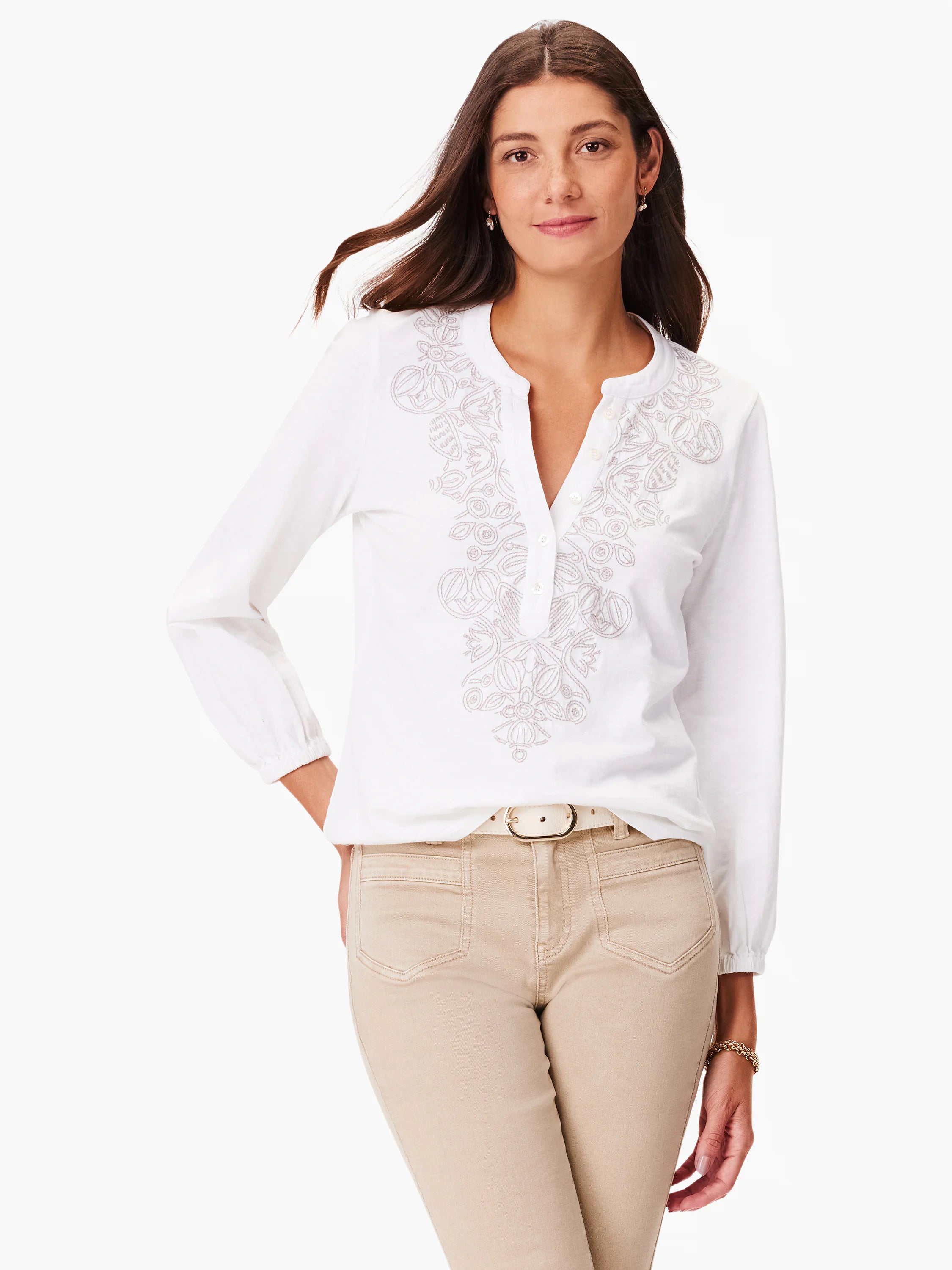 White long-sleeve top with a light gray embroidered floral design down the front. Henley-style placket.