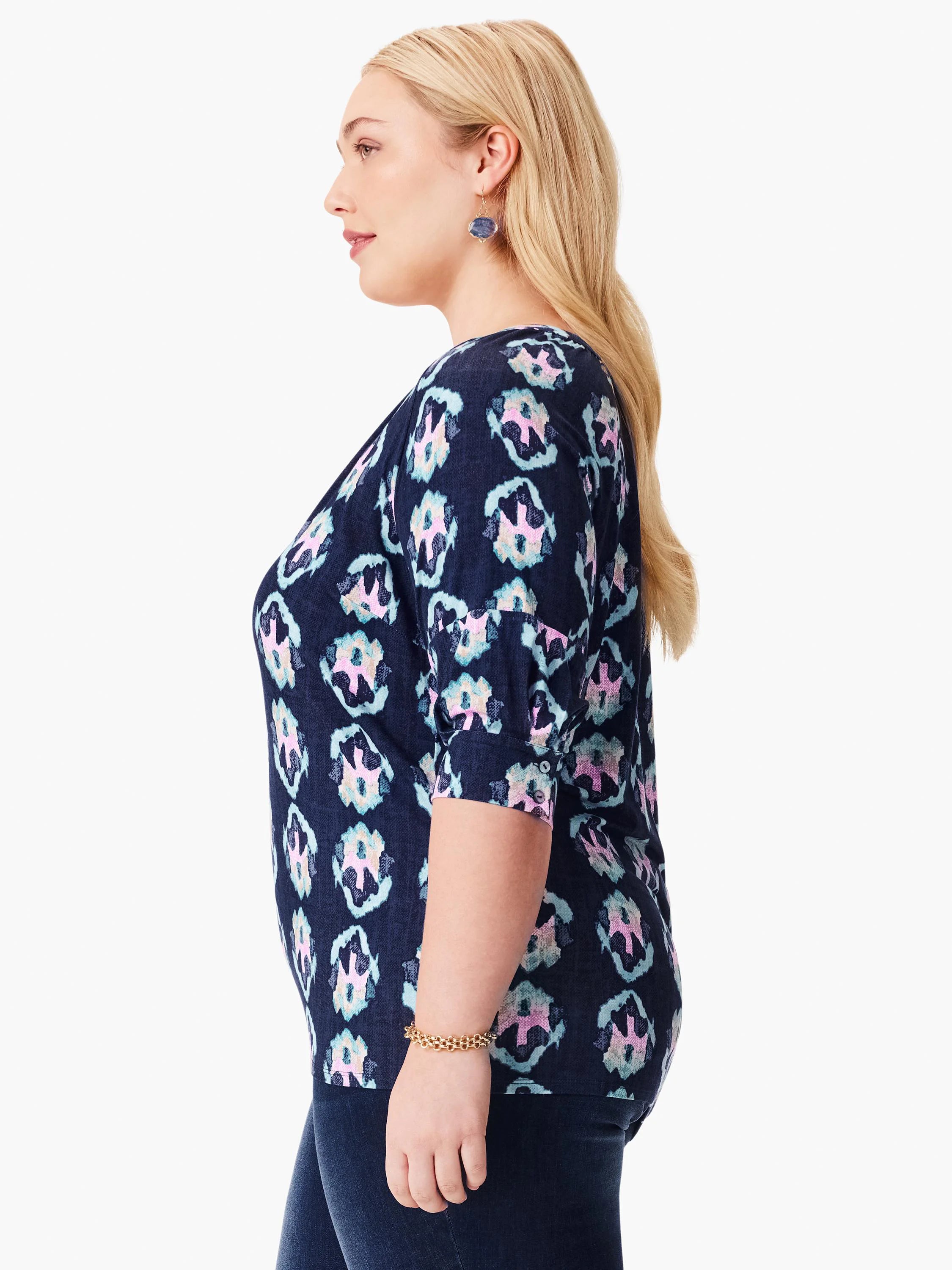 Navy blue top with teal, pink, and white batik pattern. Three-quarter sleeves, v-neck.