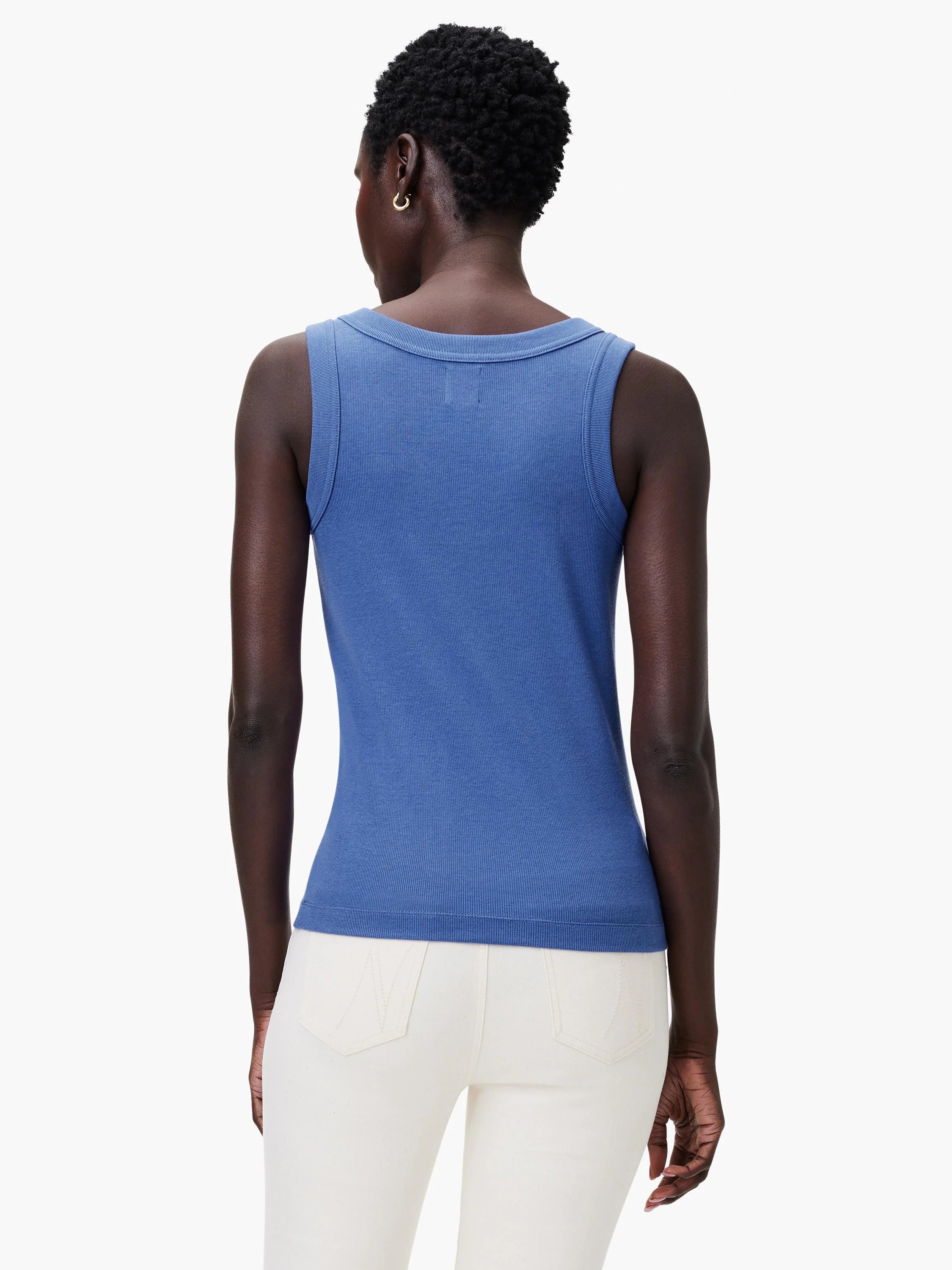 Model's back in a blue ribbed knit tank with a scoop neck and fitted body.