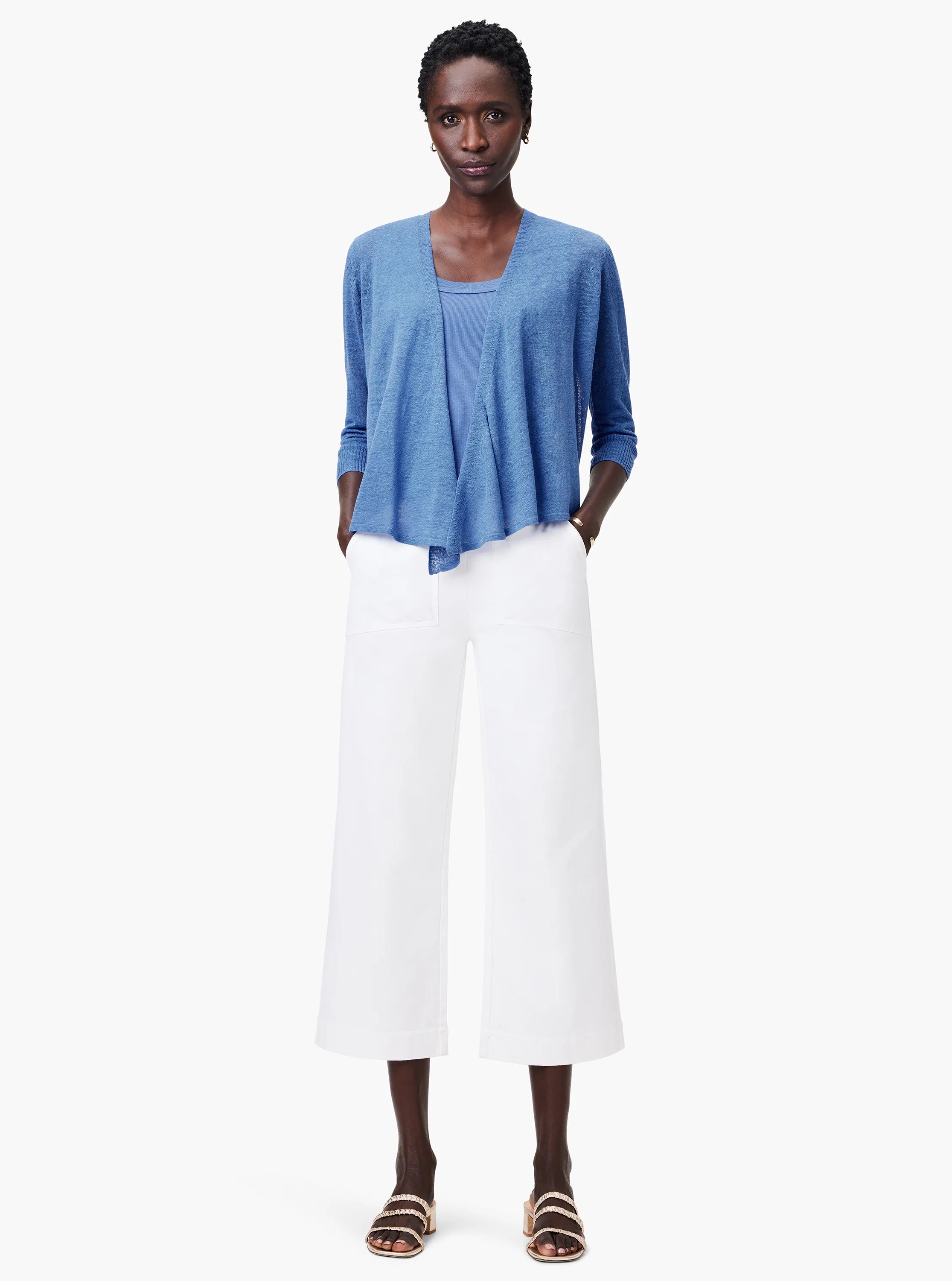 Light blue ribbed scoop neck tank top, worn on a model beneath a blue open cardigan.