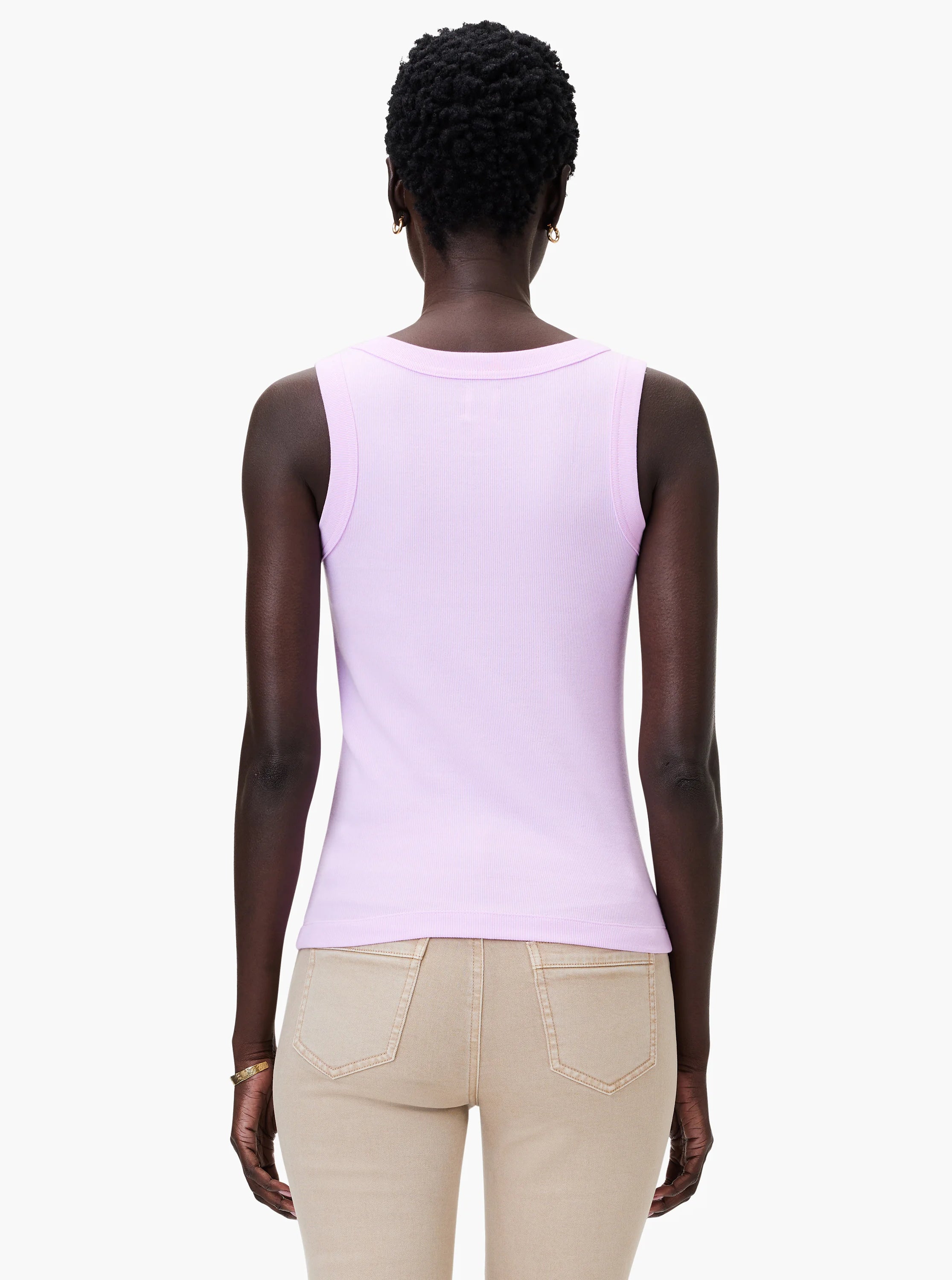 Light purple ribbed knit scoop tank, back view, worn by model. Paired with tan pants.