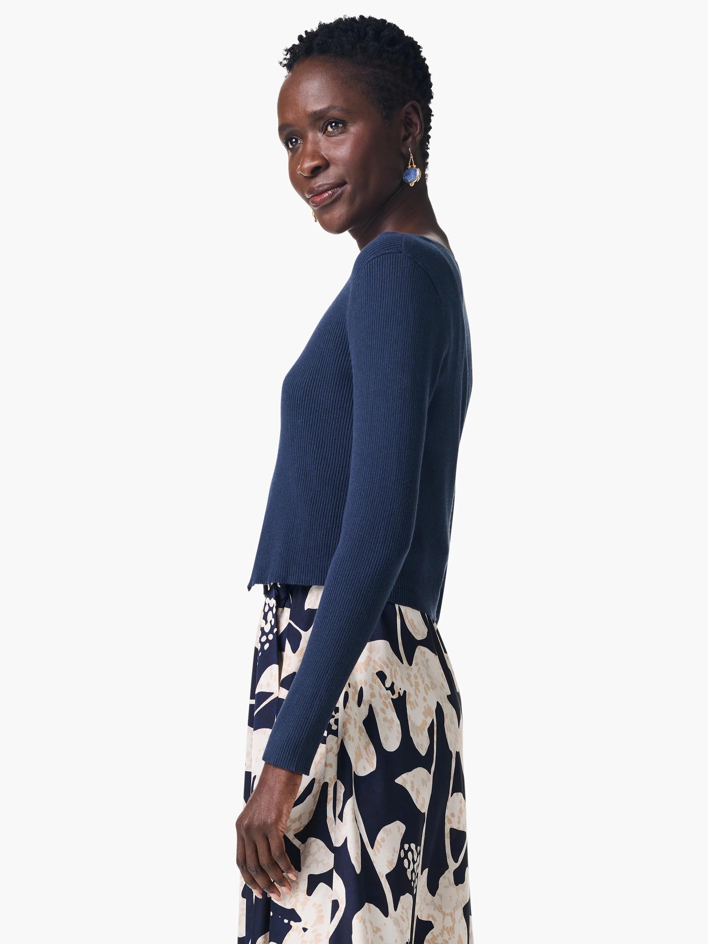 Navy blue ribbed cardigan, cropped length, long sleeves.