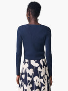 Here's alt text for the image:
Dark blue, ribbed knit cardigan; long sleeves, square neckline.