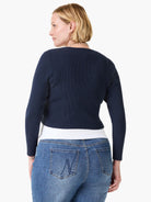 Navy blue ribbed knit cardigan, long sleeves, cropped length.