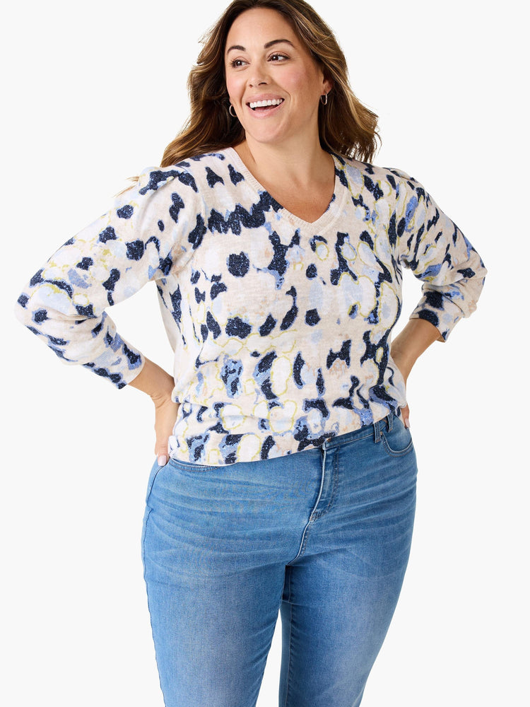 Beige sweater with blue and darker blue abstract print. V-neck, 3/4 sleeves.