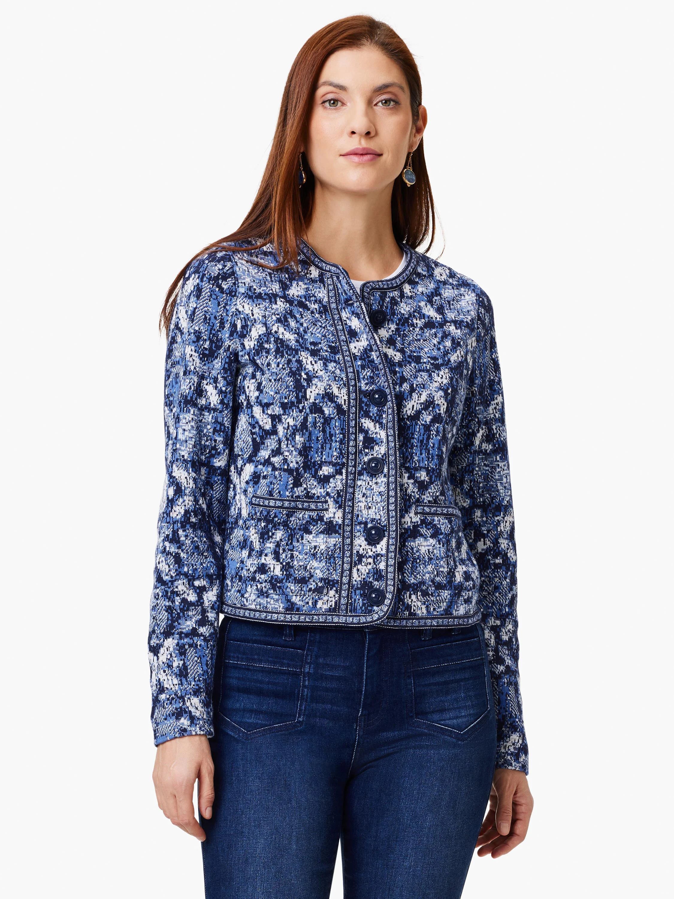 Indigo blue knit jacket with white and lighter blue geometric pattern. Button front, cropped length.