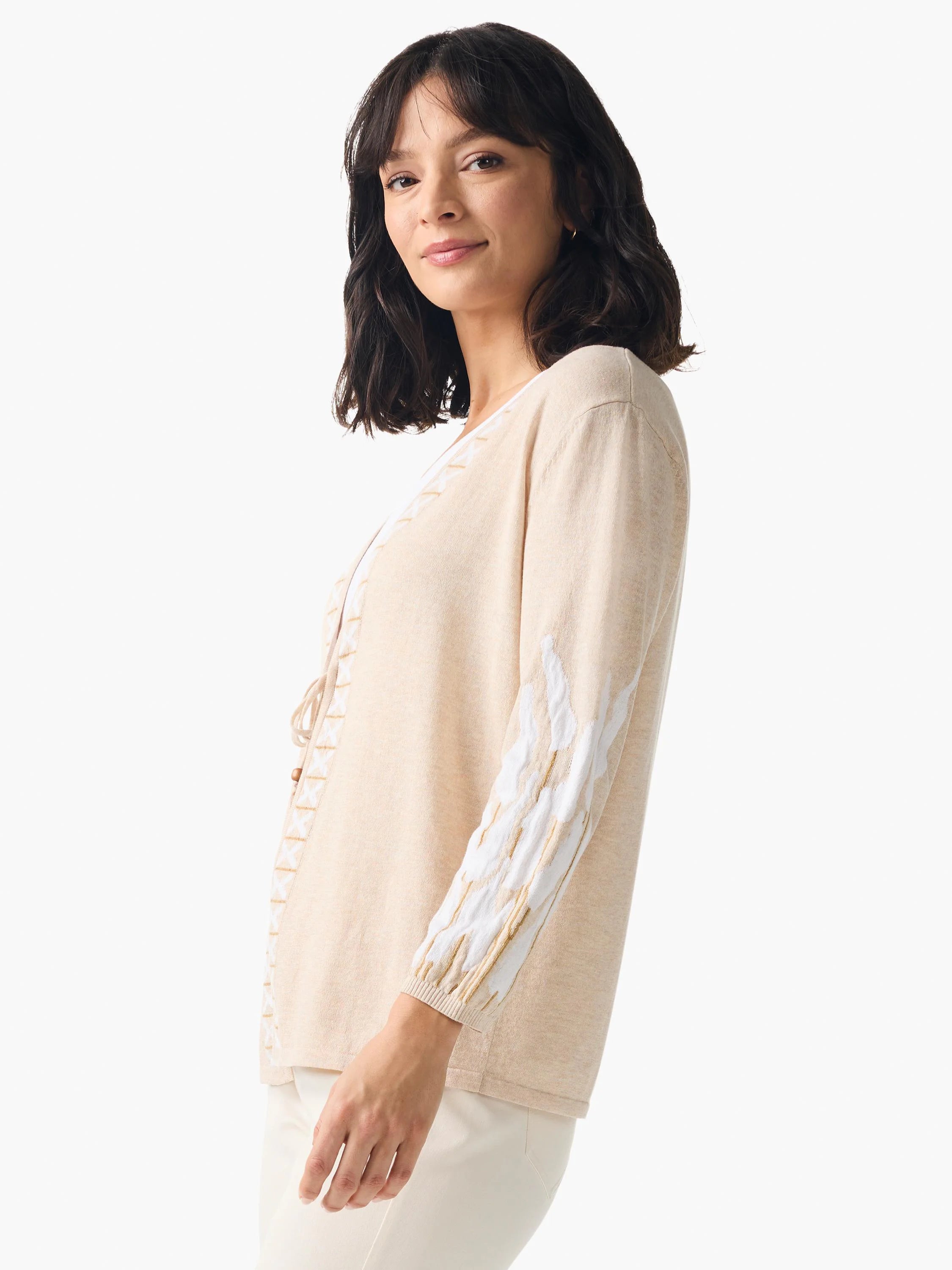 Beige cardigan with white and gold embroidered detail on sleeves and front. Three-quarter sleeves. Open front.