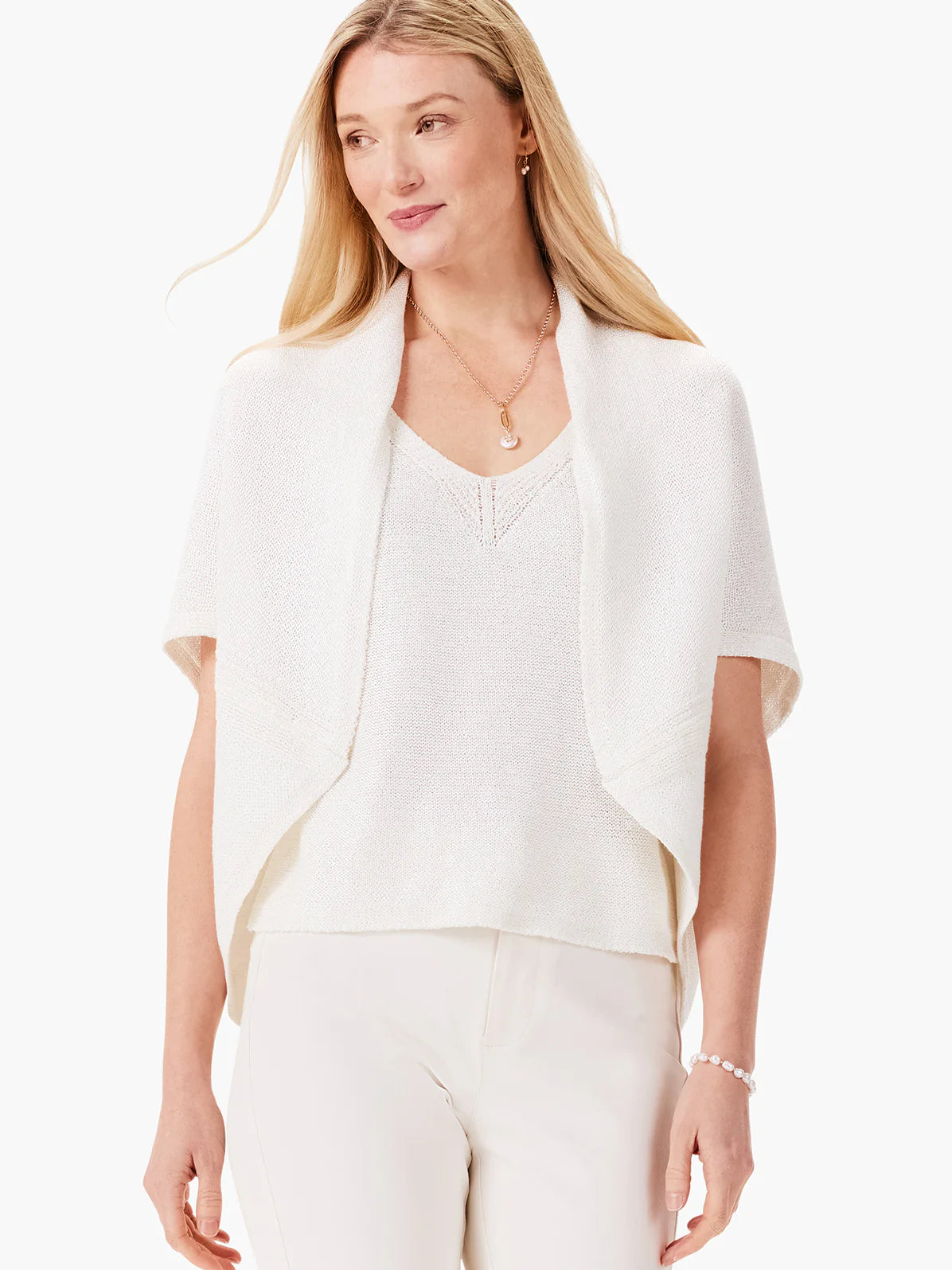 Off-white short-sleeved open-front cardigan. Slightly textured knit fabric. Model is wearing it over a matching...