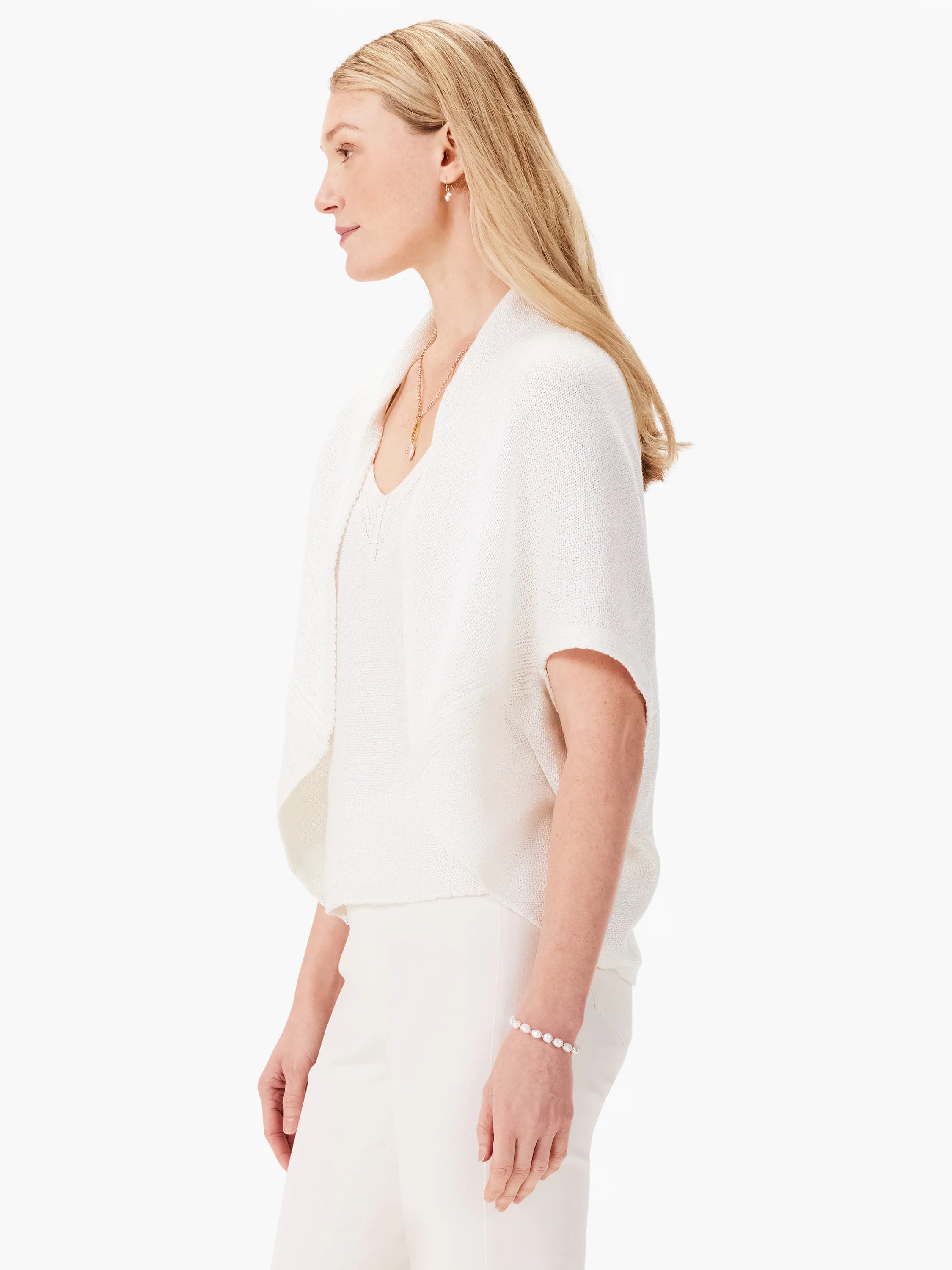 Off-white short-sleeved open cardigan, shown in profile. Knit fabric.