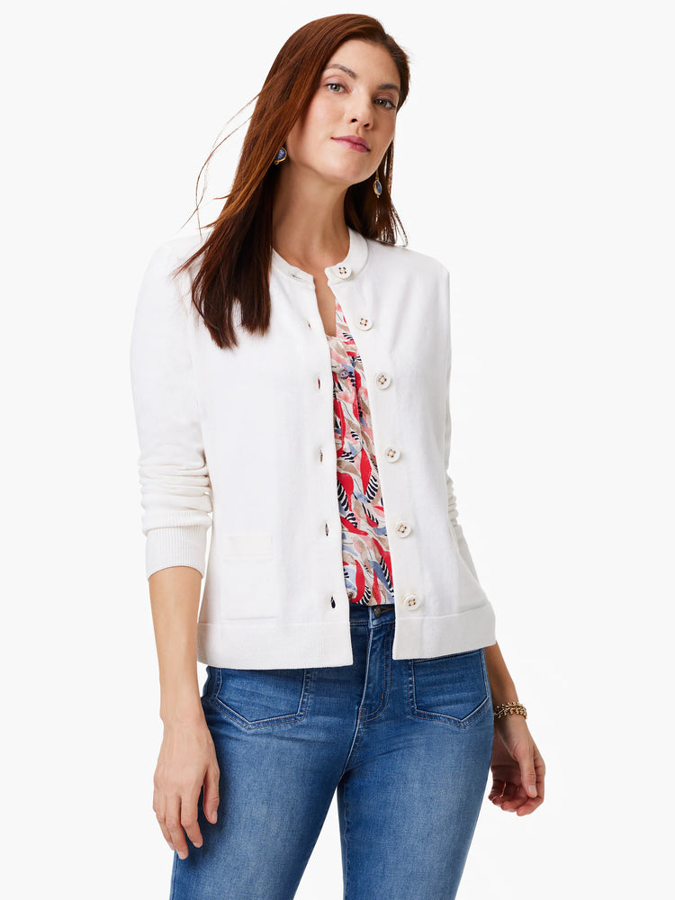 Off-white cardigan with gold buttons, front pockets, and long sleeves.