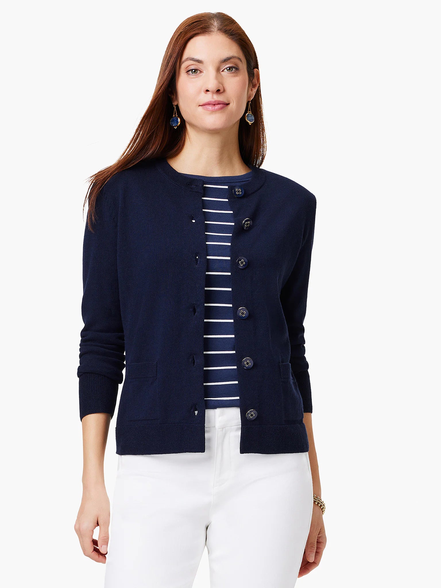 Navy blue cardigan with dark buttons and patch pockets. Shown buttoned, long sleeves.