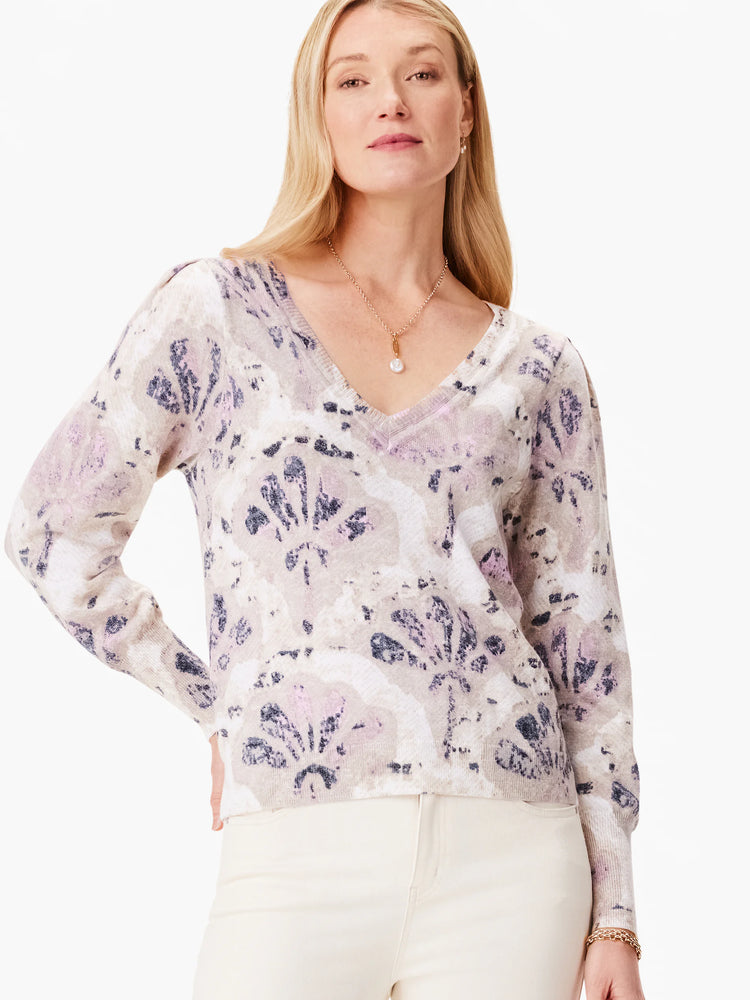 Beige sweater with purple and dark gray abstract floral pattern. V-neck, long sleeves.