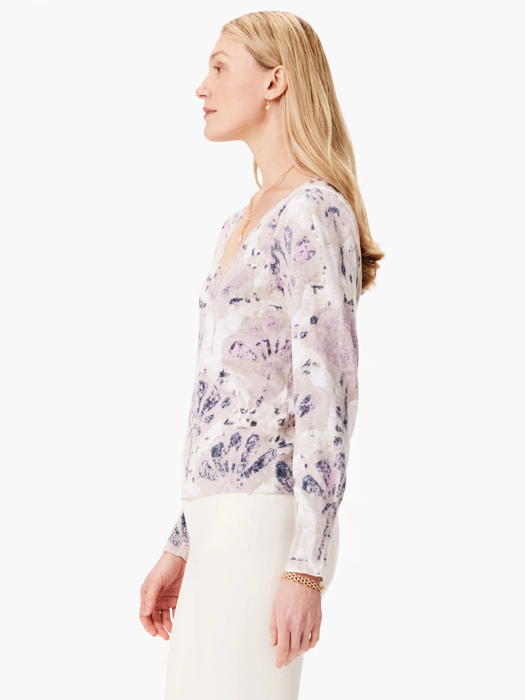 Beige sweater with lavender and gray abstract print, V-neck, long sleeves.