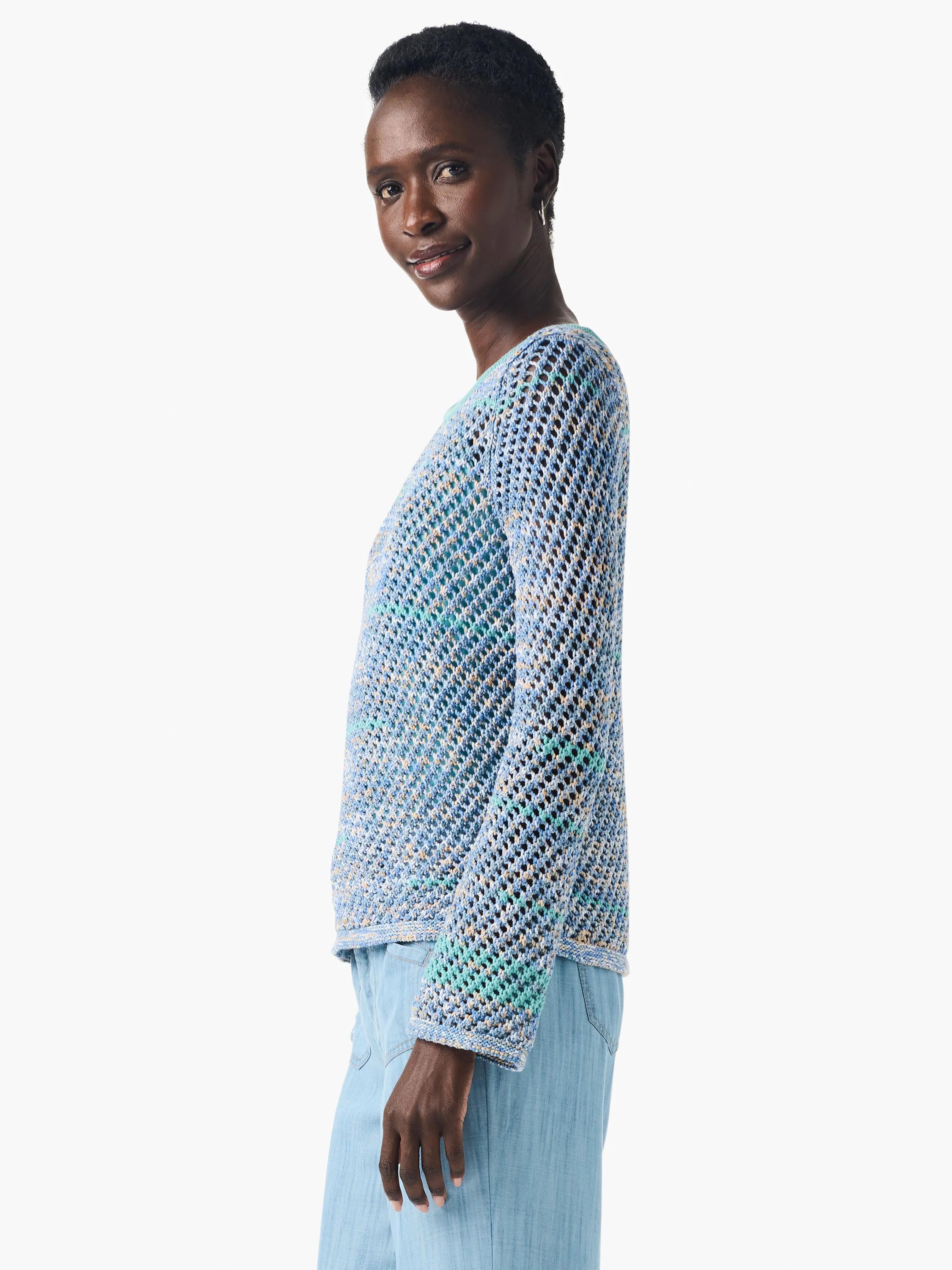 Crochet sweater in light blue, teal, and beige; open, loose weave; long sleeves.