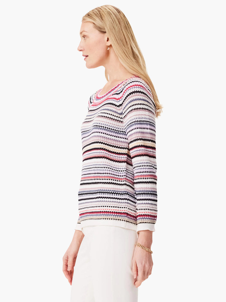 Cream sweater with horizontal stripes in pink, red, black, gray, and beige. Long sleeves, boat neck.