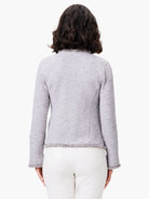 Light grey mixed knit jacket, back view. Features fringe trim at the neckline, cuffs, and hem.