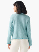 Aqua mix knit jacket with fringe trim at neck, hem, and cuffs.