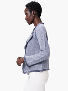 Periwinkle and white tweed jacket with fringe trim along the neckline, cuffs, and hem.