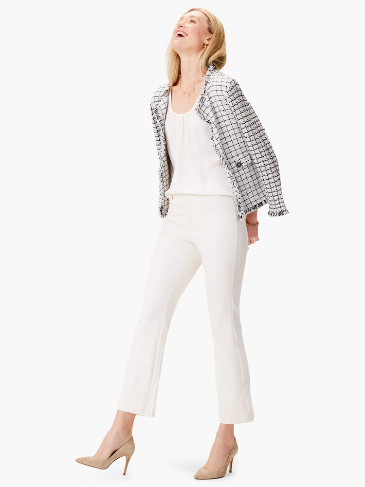 White and black grid pattern knit jacket with frayed edges. Features pockets.