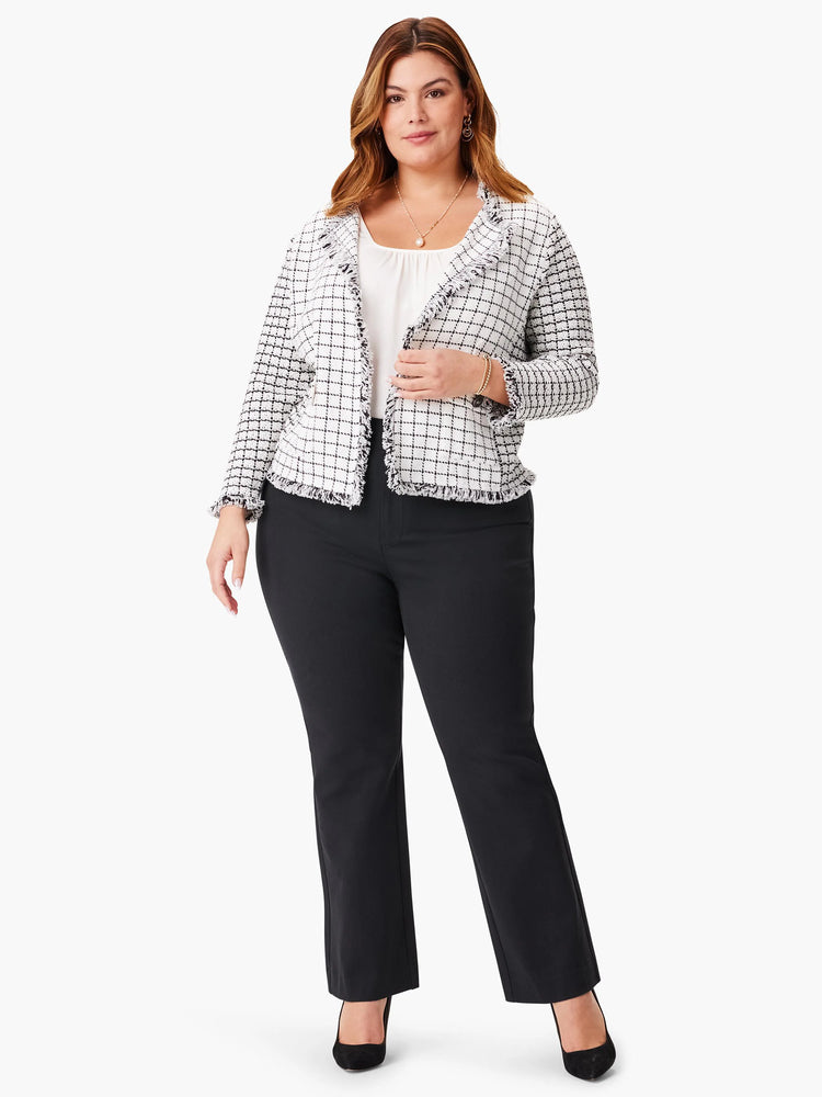 White and black grid pattern knit jacket with frayed edges. Model shown wearing it with black pants.