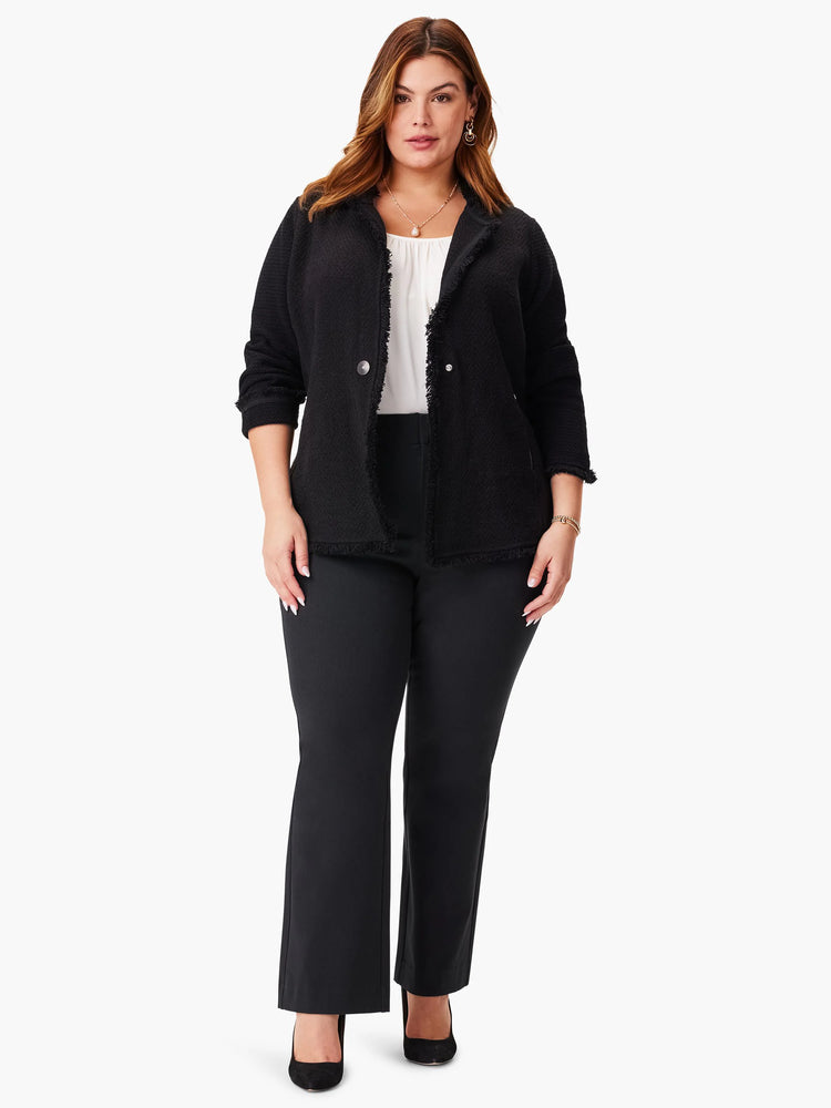 Black knit jacket with long fringe detailing. Features two buttons.