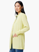 Pale yellow long-sleeve cardigan with pockets and ribbed side detailing.