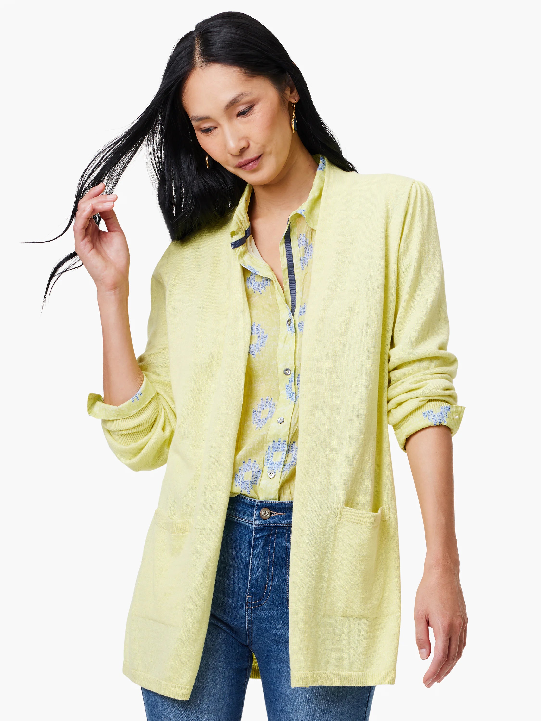 Pale yellow cardigan with patch pockets.  Open front. Model wears it over a pale yellow and blue patterned shirt.