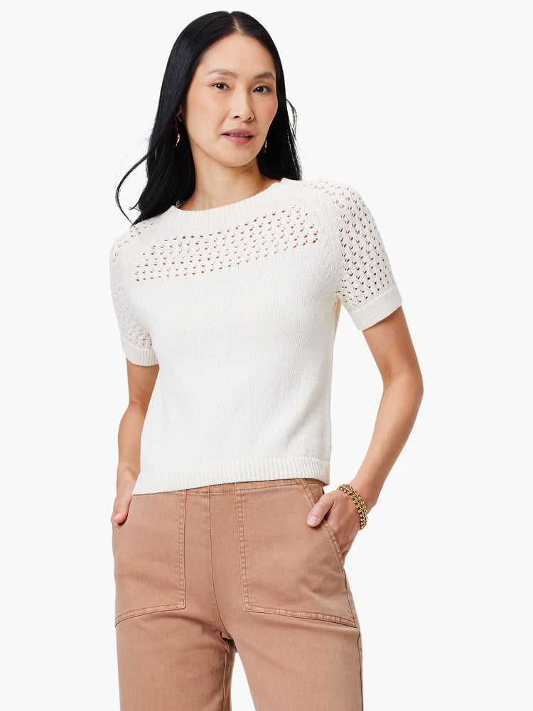 Off-white crochet-detail sweater tee. Short sleeves. Crew neck. Lace-like pattern on yoke and sleeves.
