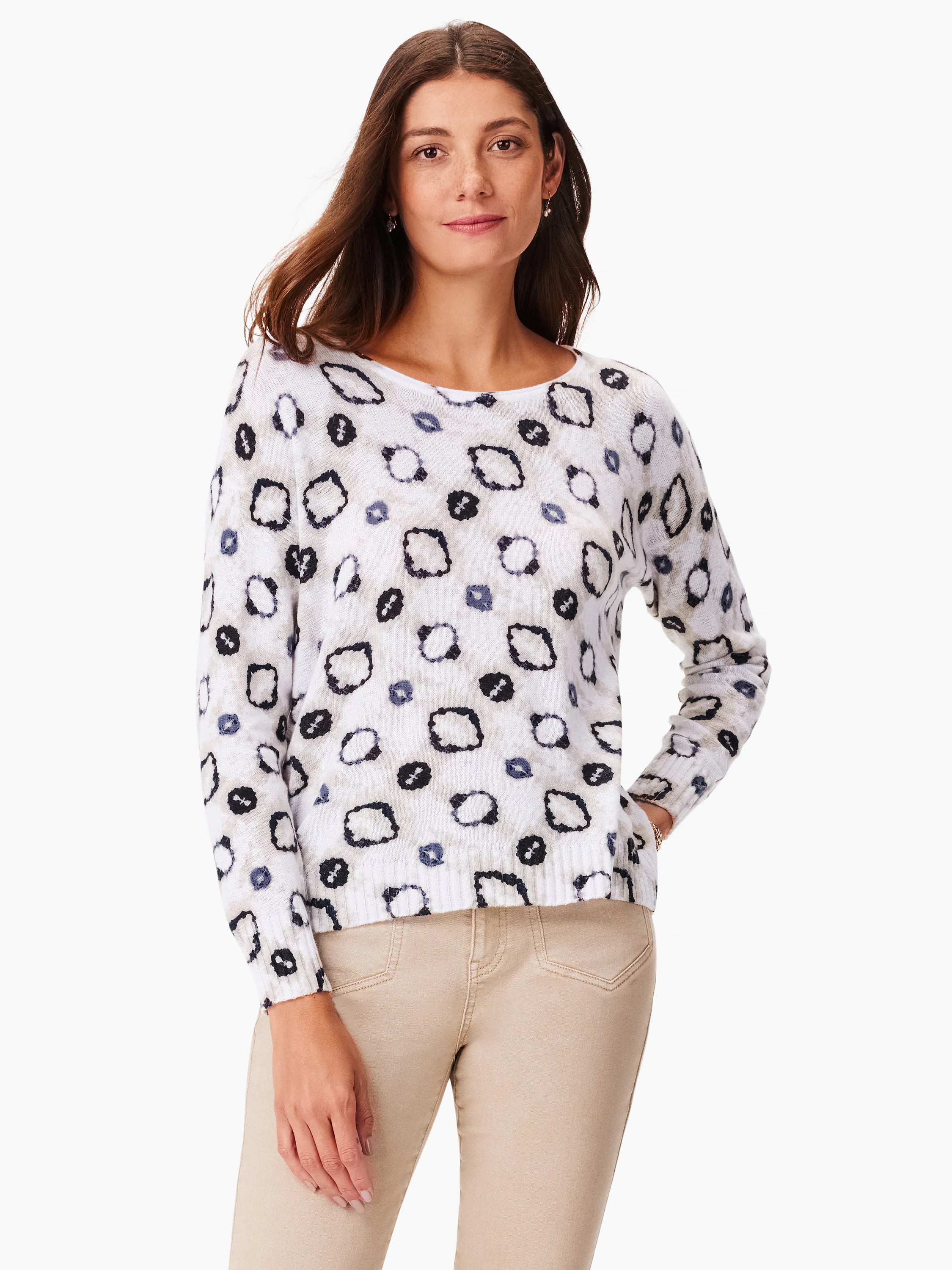 White sweater with gray, black, and beige abstract pattern. Long sleeves, round neckline.