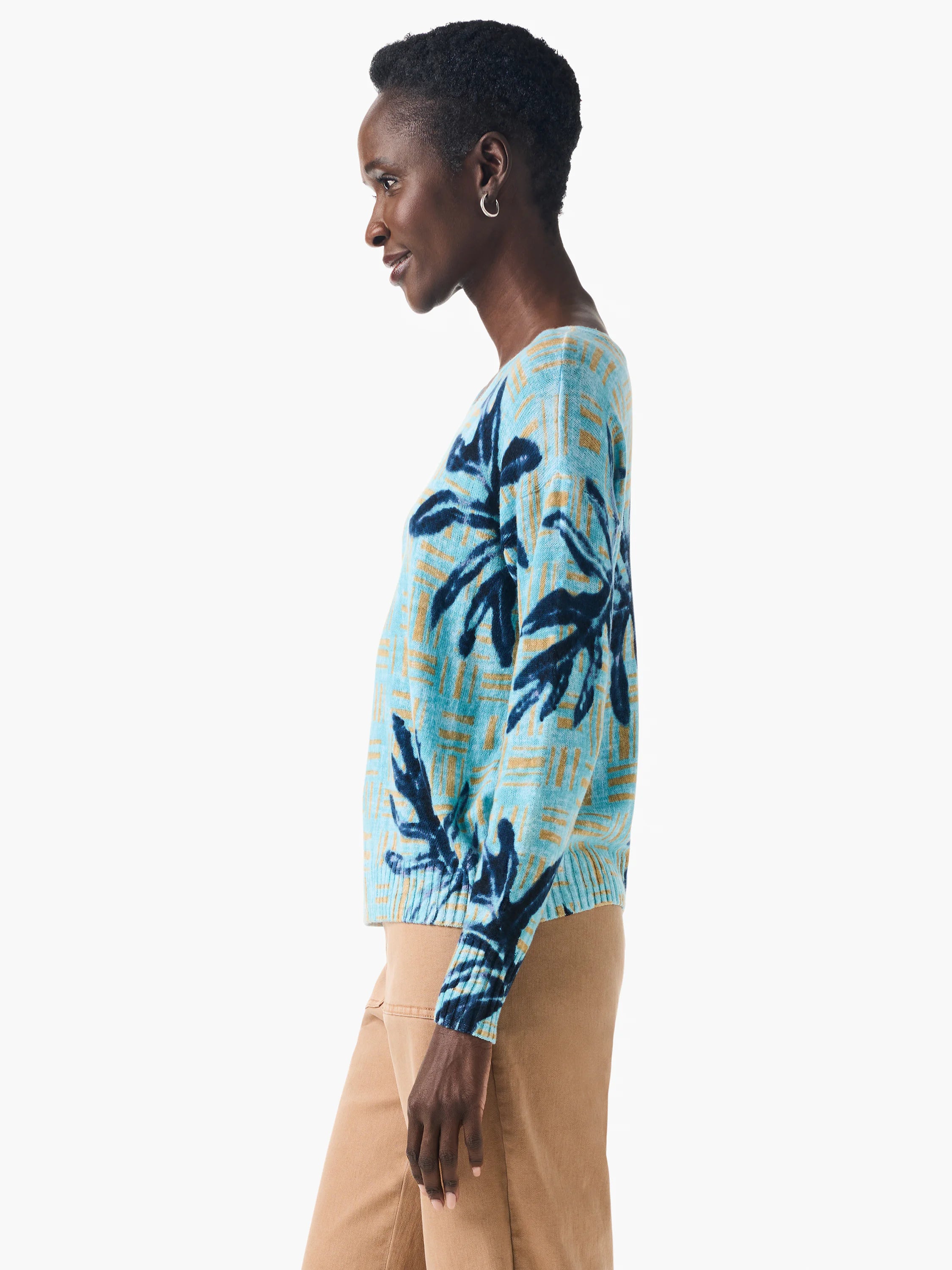 Light blue sweater with dark blue and gold leaf pattern. Long sleeves, relaxed fit.