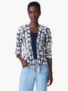 Here's alt text for the image, following accessibility best practices:
"4-way cardigan in off-white with blue and black...