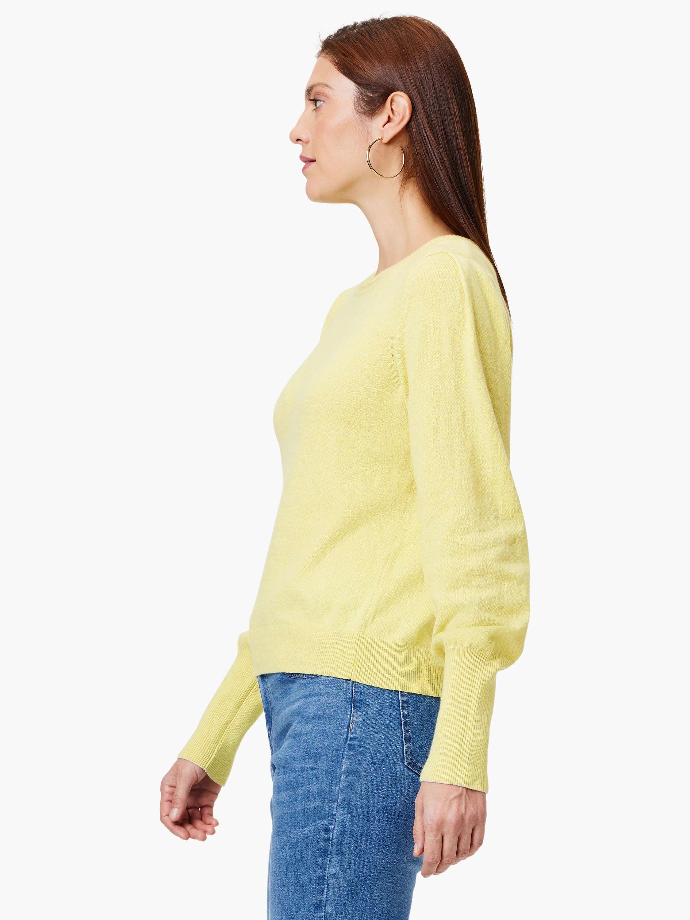 Light yellow sweater with voluminous sleeves, ribbed cuffs and hem. Model faces left.