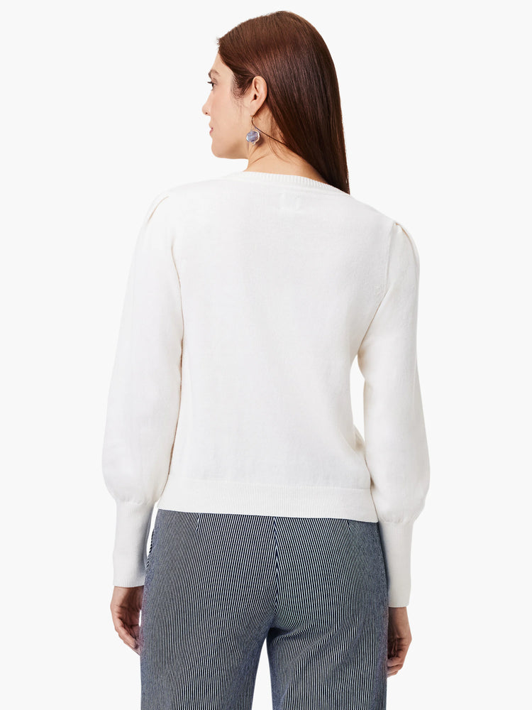 Off-white sweater, back view. Features include a round neck, puff sleeves with ribbed cuffs, and a ribbed hem.
