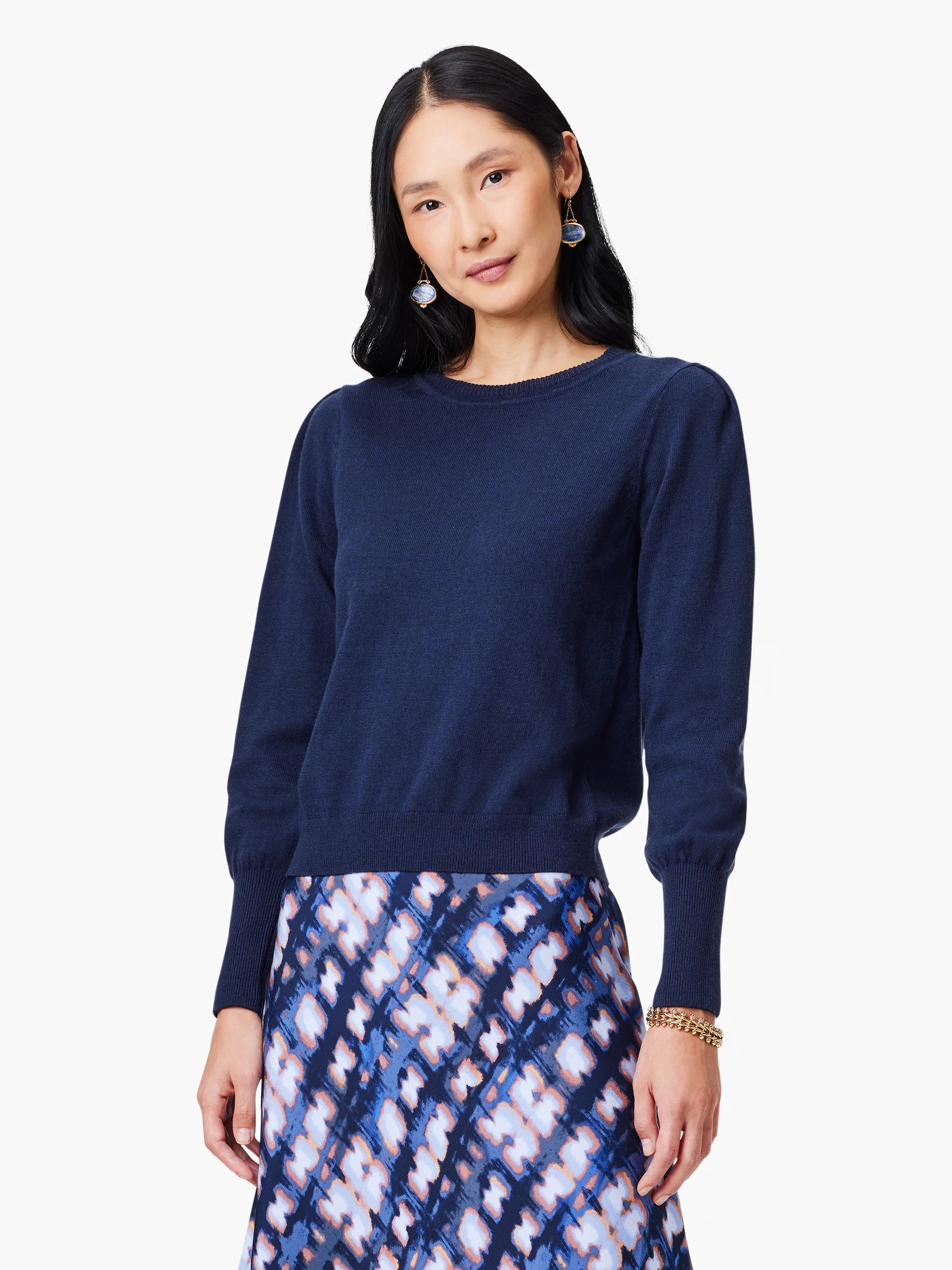 Navy crew neck sweater with puffed long sleeves, ribbed cuffs, and hem.