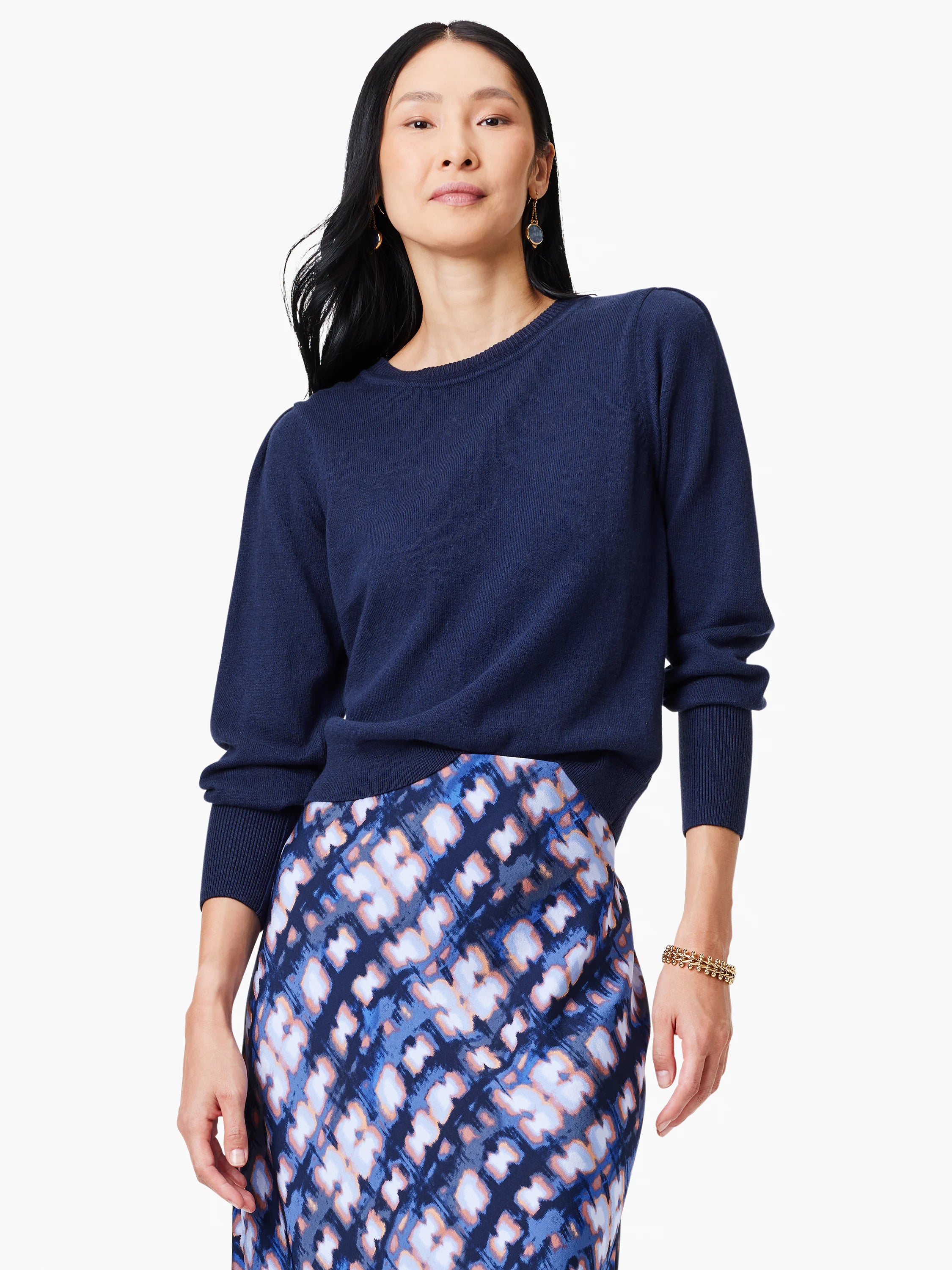 Navy crewneck sweater with puff sleeves and ribbed texture on the body, cuffs, and hem.