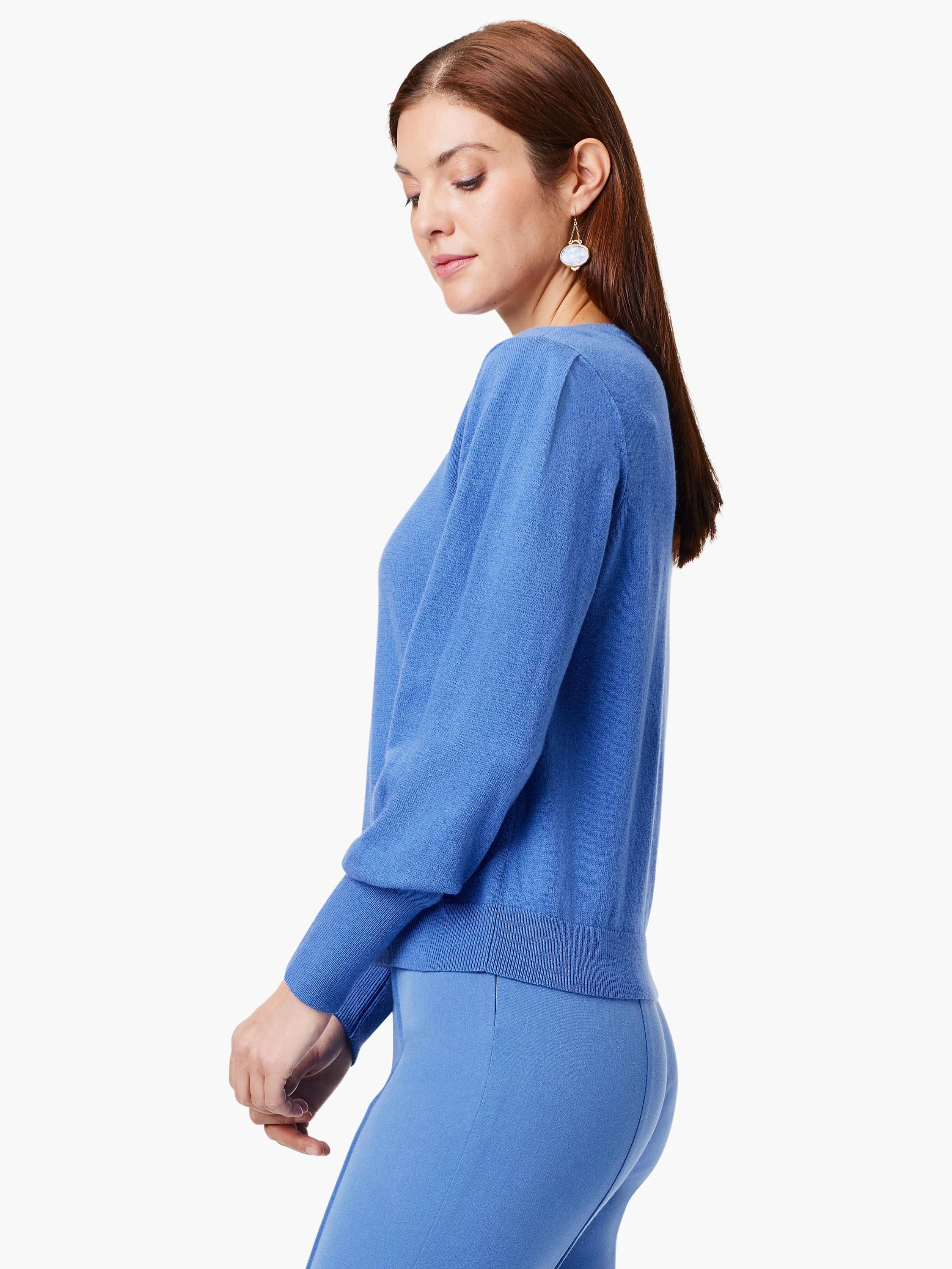 Periwinkle blue sweater with round neck, subtle shoulder gathers, and ribbed cuffs.