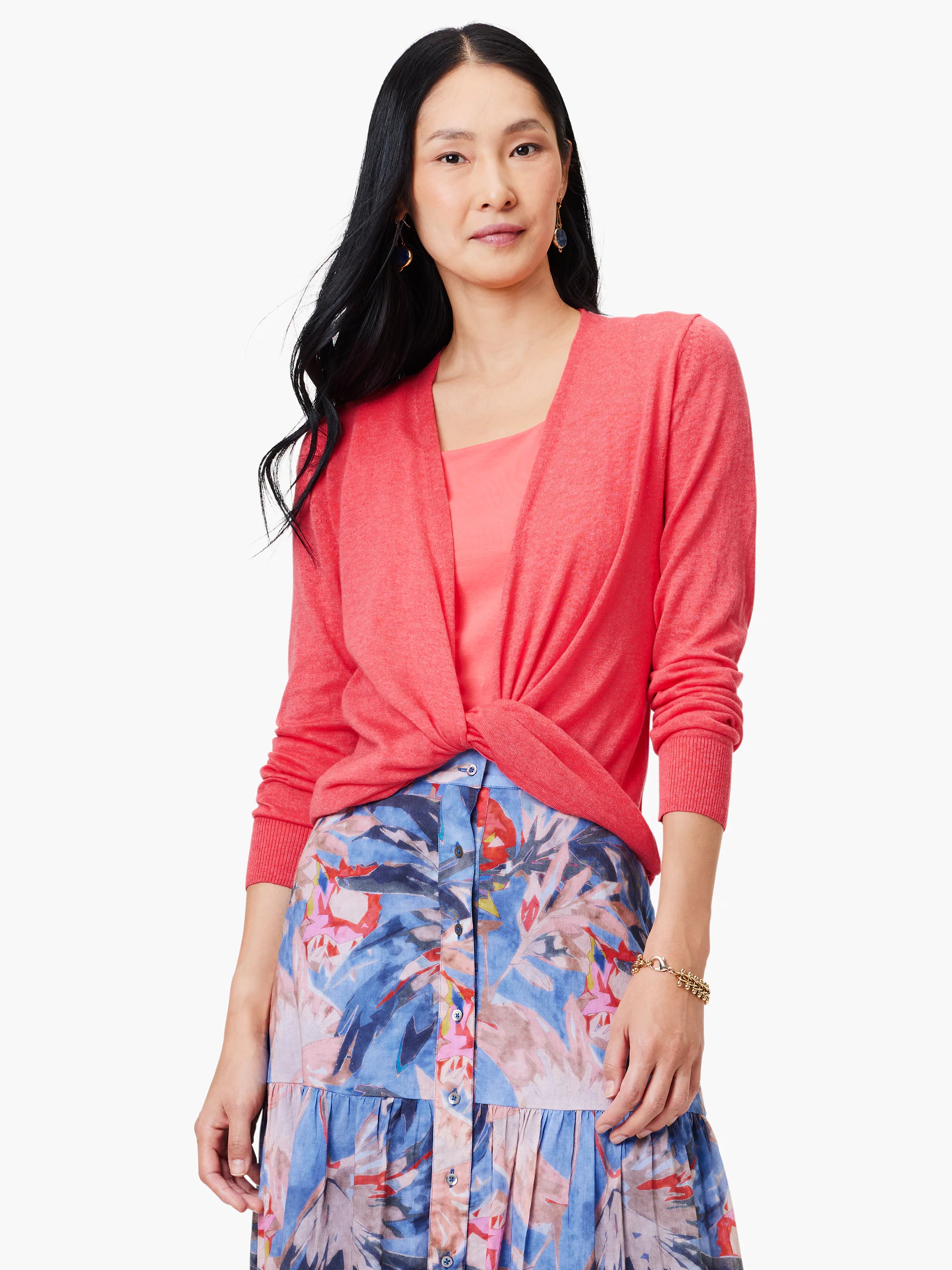 Coral long-sleeve cardigan with ribbed cuffs, shown tied in a knot at the front. Features a lightweight knit material.