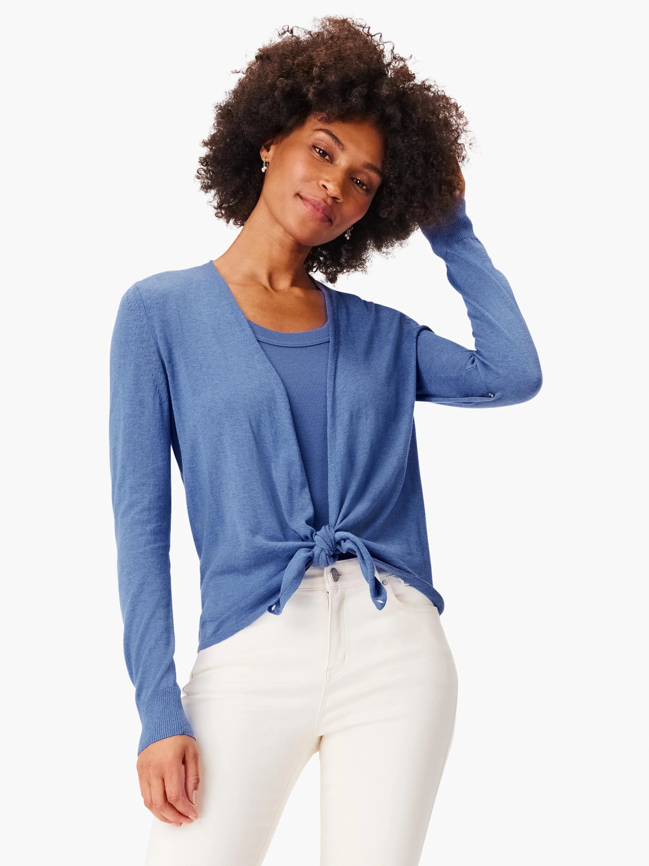 Blue long-sleeve cardigan, finely knit, styled tied at the waist over a matching tank top.