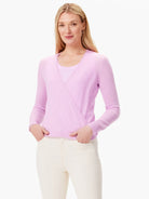 Light purple long-sleeve wrap cardigan on a woman, worn over a tonal top.