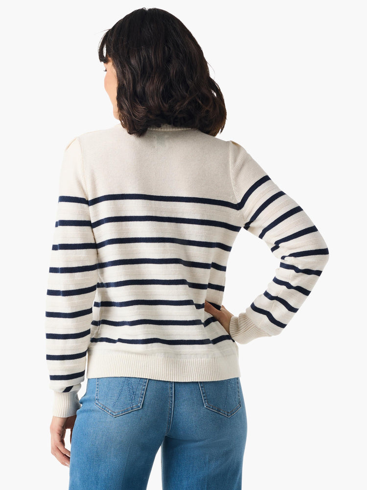 Cream cashmere sweater with navy blue horizontal stripes, long sleeves, and ribbed cuffs. Shown from the back.