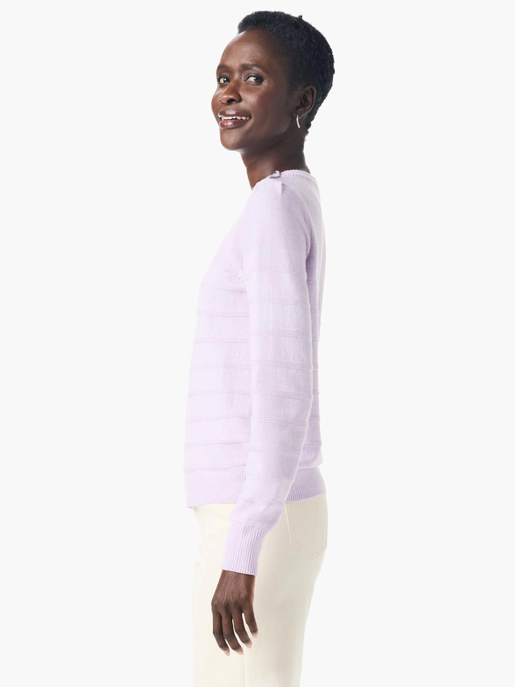Lavender cashmere sweater with subtle horizontal stripes, button detailing on shoulders, long sleeves, and ribbed cuffs.