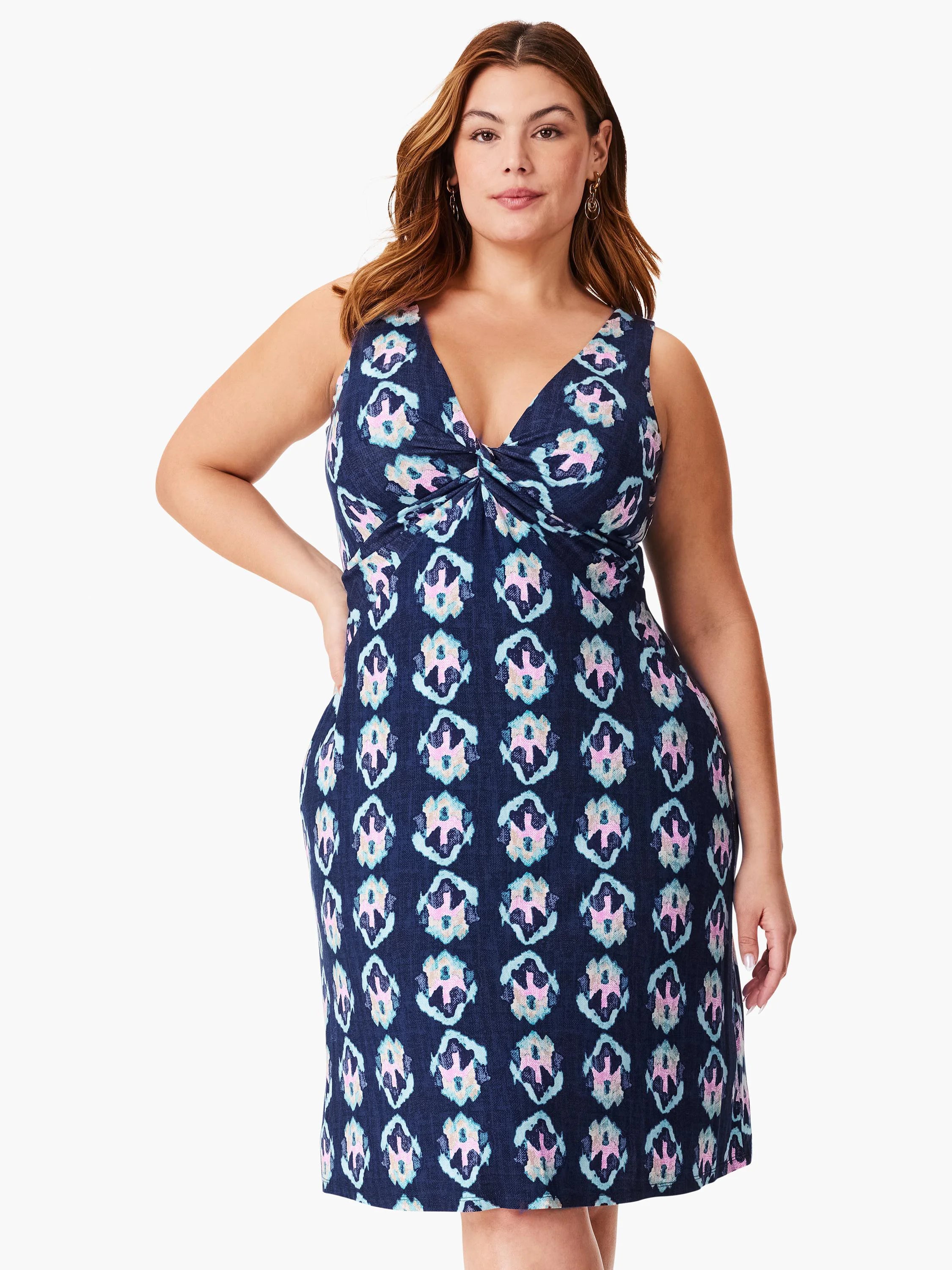 Navy sleeveless dress with a V-neck and knotted bodice. Features a repeating light blue, pink, and white ikat pattern. ...