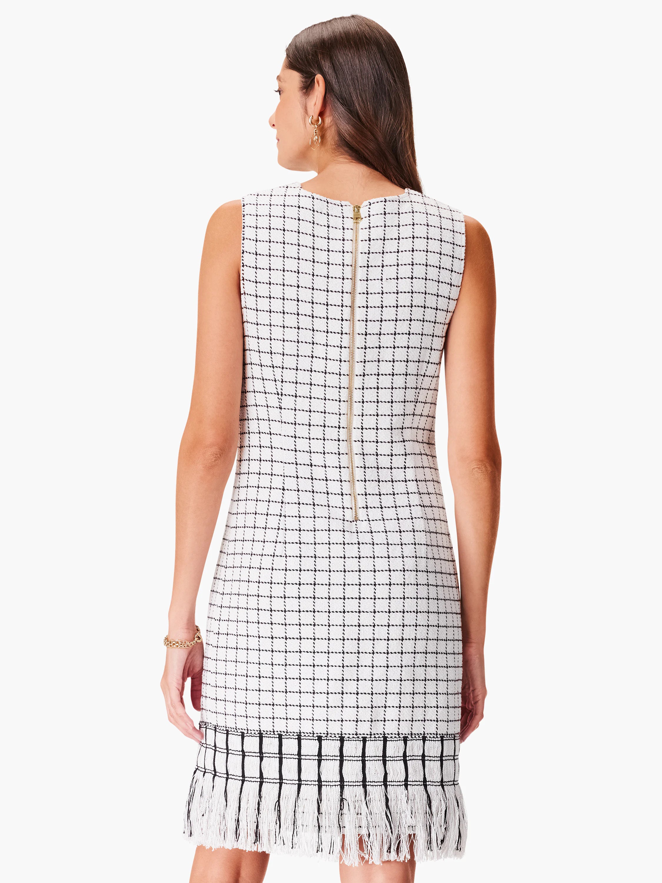 White sleeveless dress with black grid pattern and a fringe bottom. Back zipper closure.