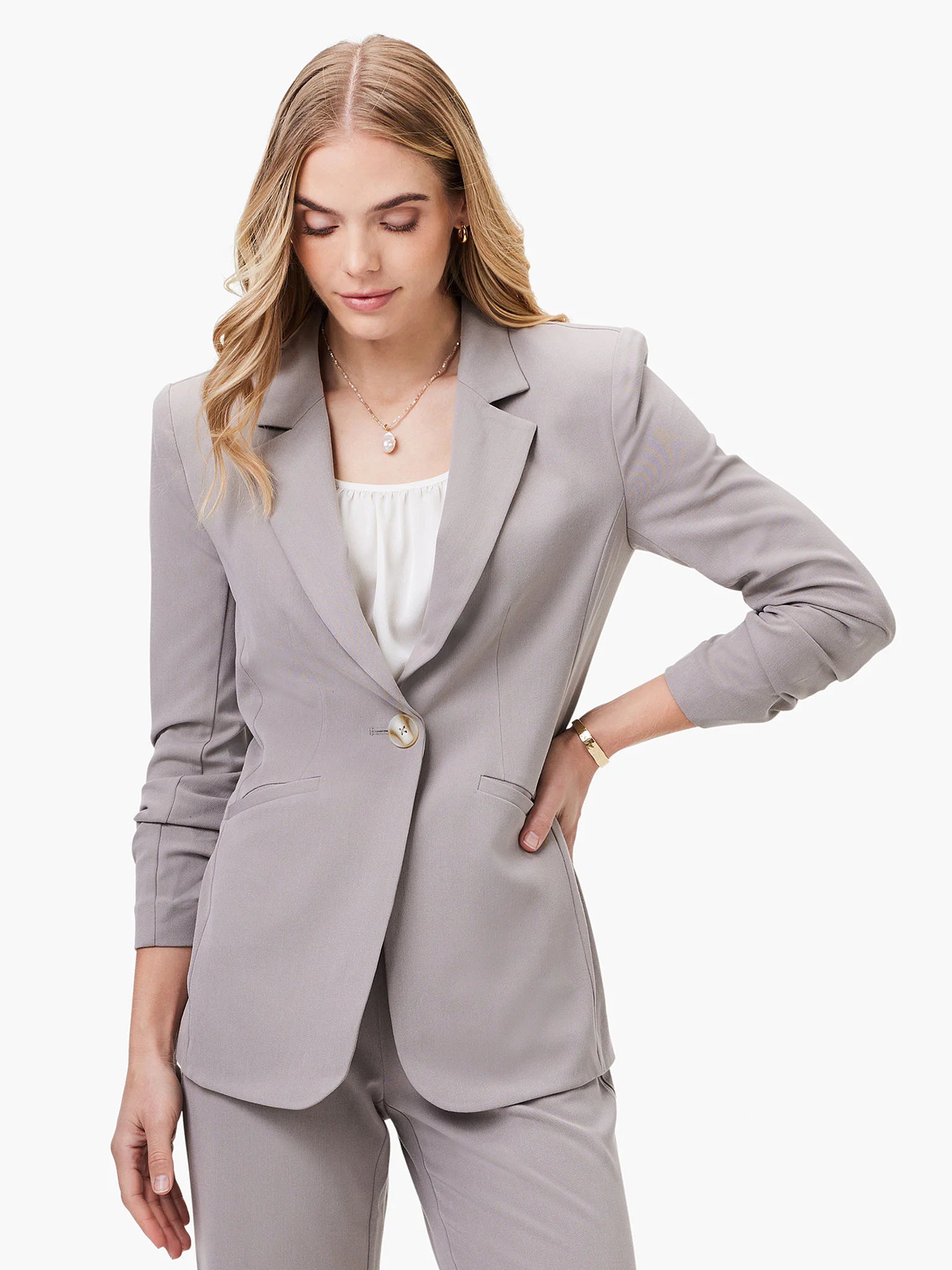Gray blazer, single button, notched lapels, scrunch sleeves. A light gray fabric.