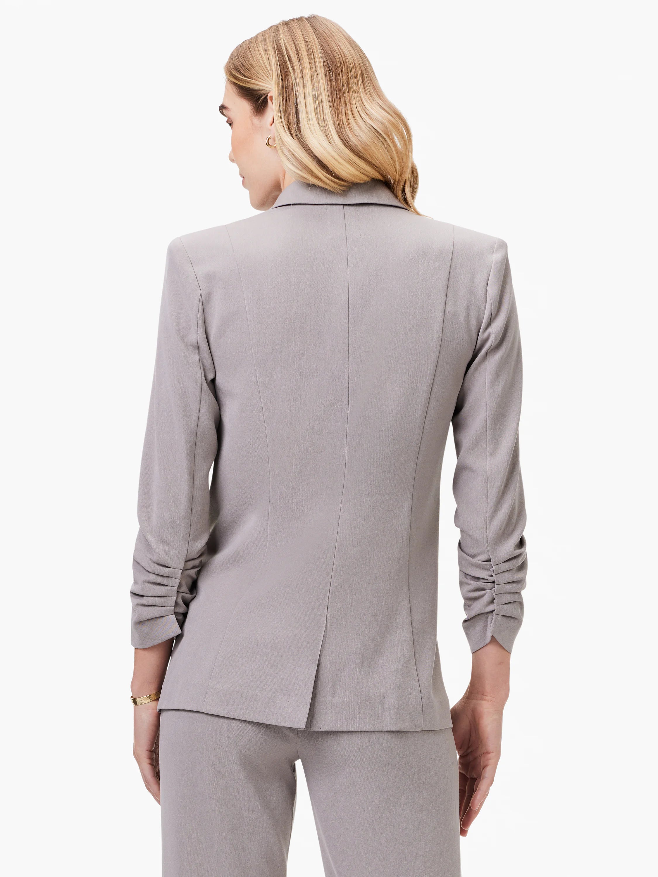 Here's alt text for the image, under 125 characters:
"Gray blazer, shown from the back. Features scrunched sleeves and...