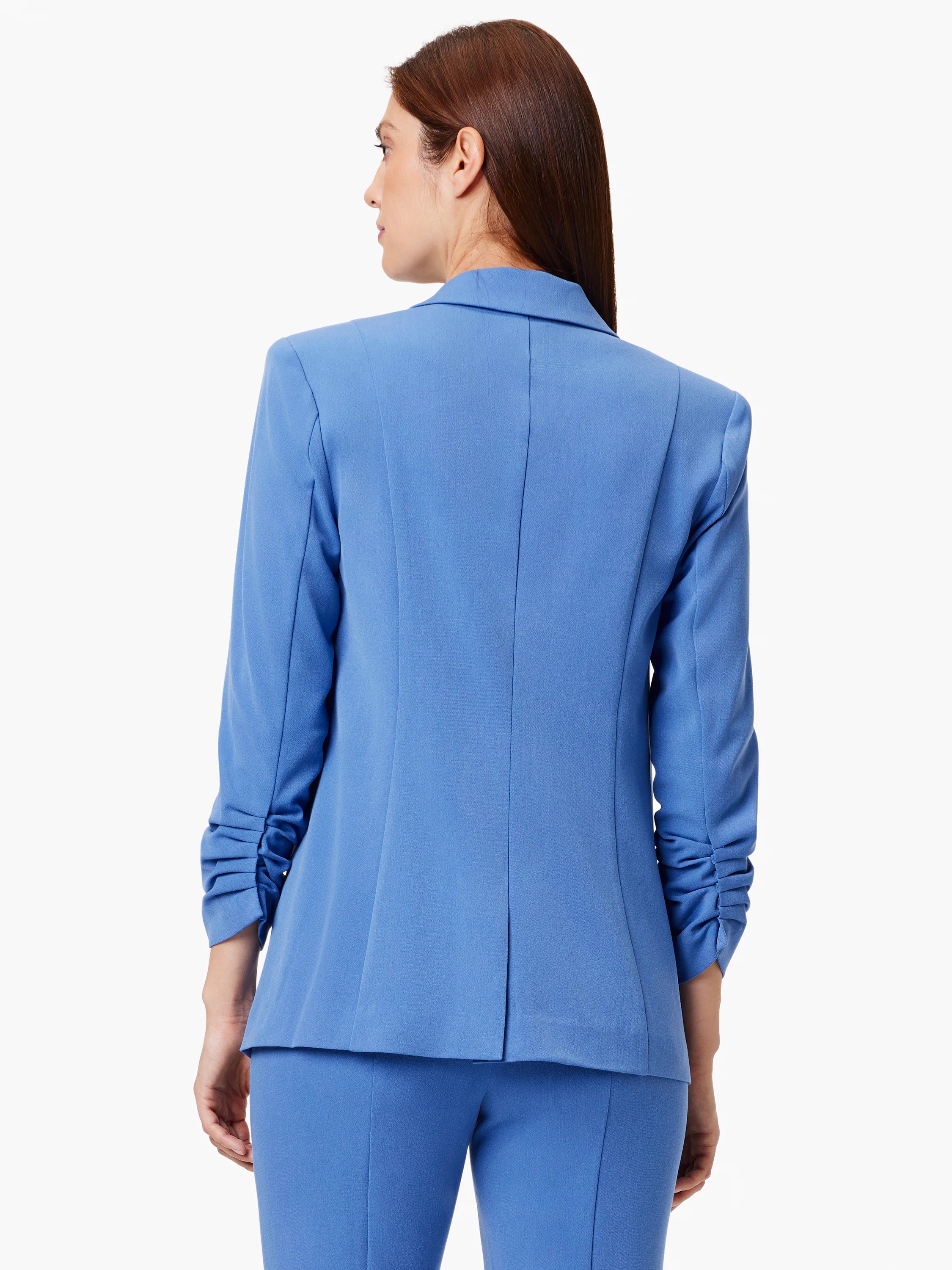 Here's alt text for the image, under 125 characters:
"Back view of a solid medium-blue blazer with scrunch sleeves. The...